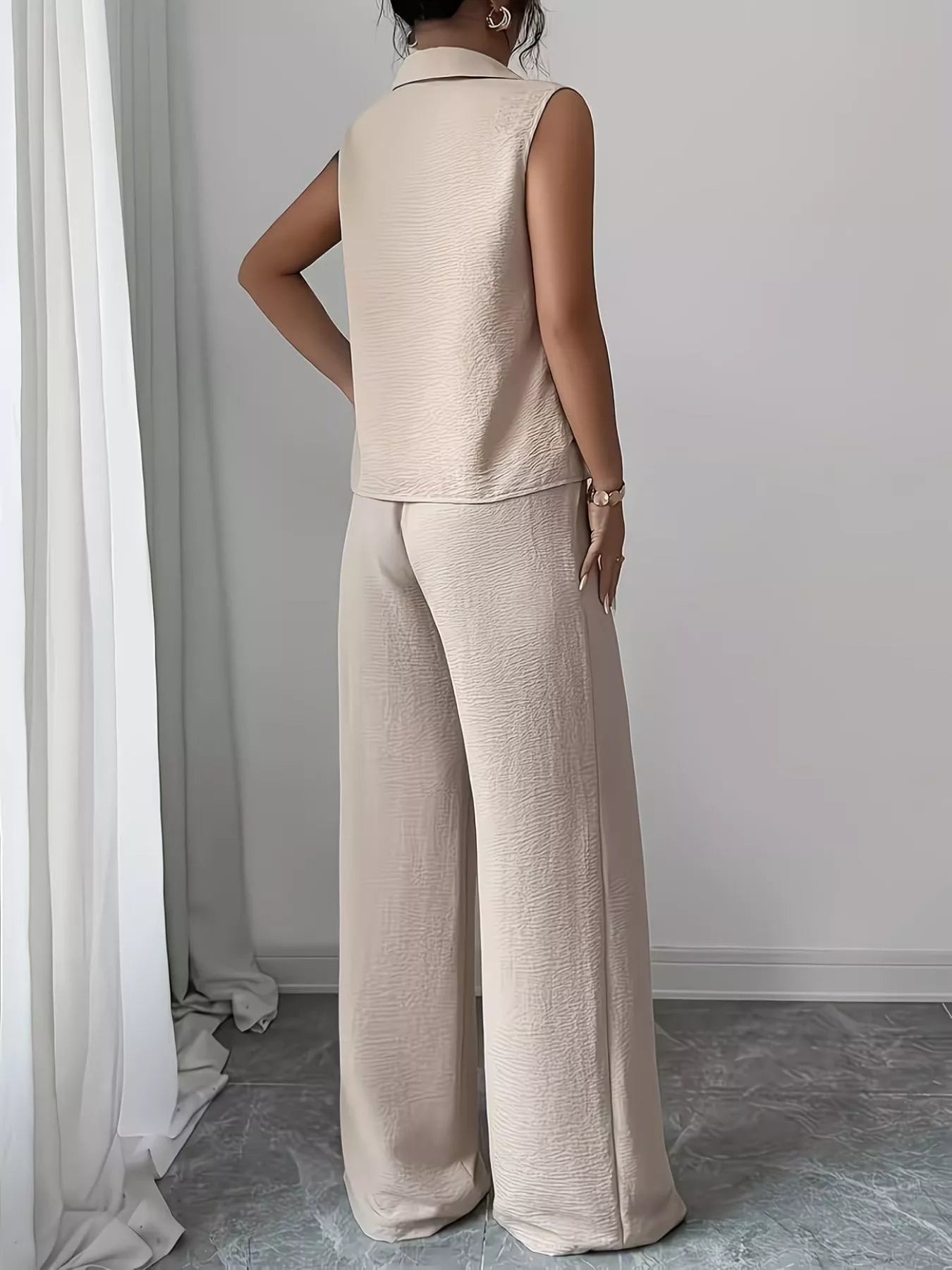 V-neck sleeveless top and wide leg pants set by Trendsi, featuring a stylish, casual outfit in a neutral fabric with a relaxed fit.
