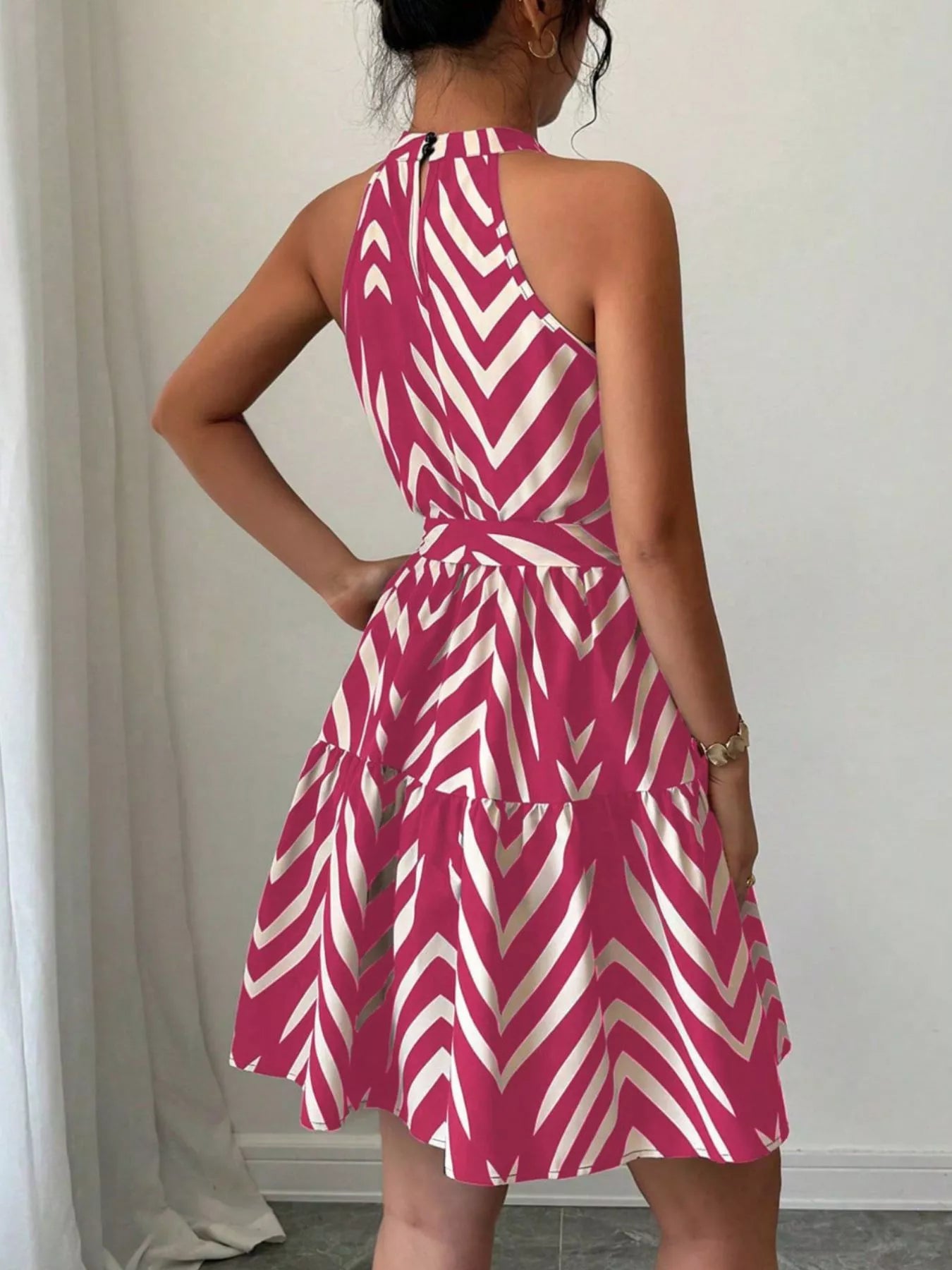 Zebra print halter neck dress with tie waist and ruffle hem, stylish trendy dress from Trendsi with bold animal pattern.