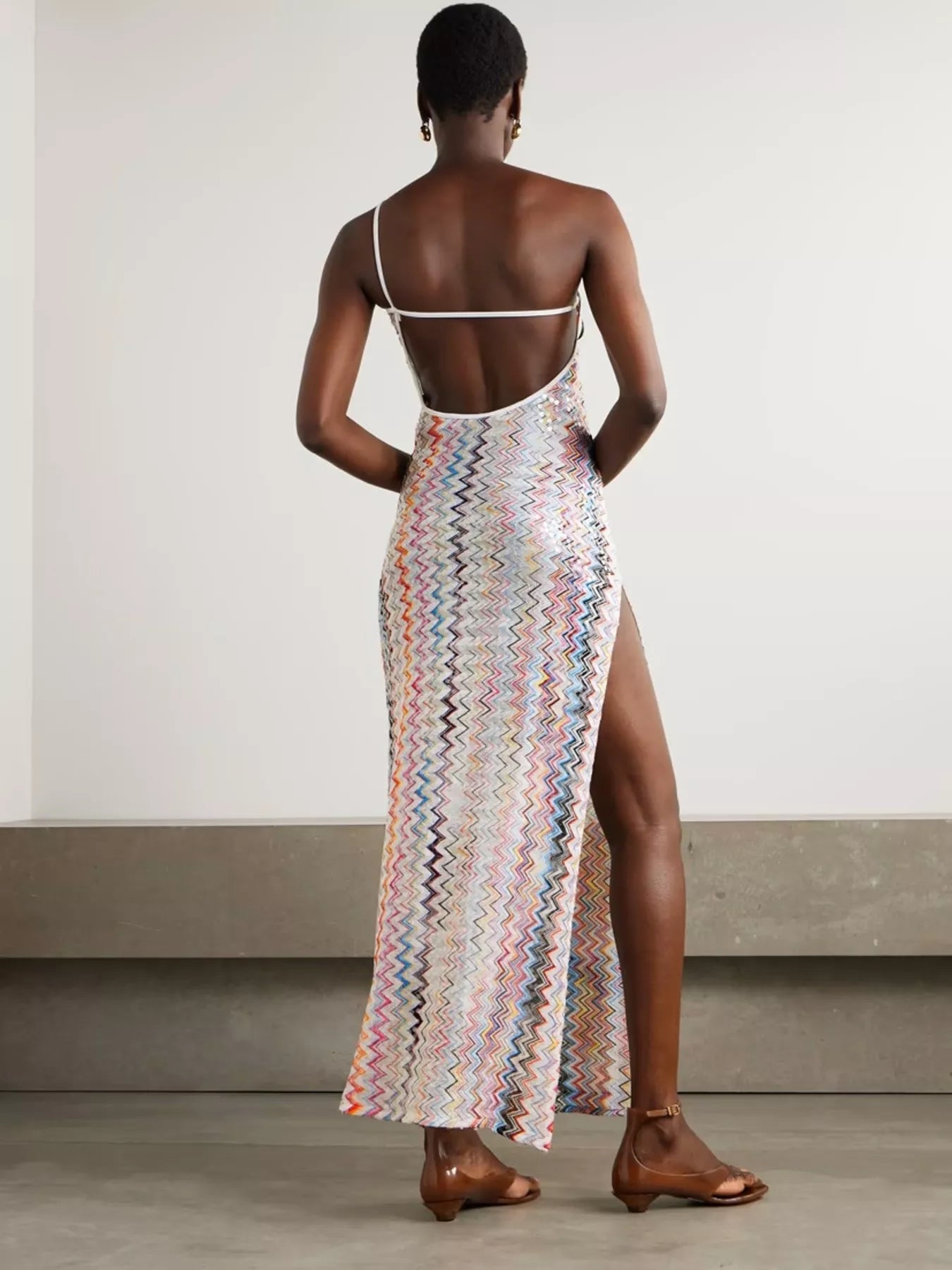 Backless zigzag pattern sleeveless maxi dress by Trendsi featuring a slit and elegant design, ideal for summer or formal occasions.