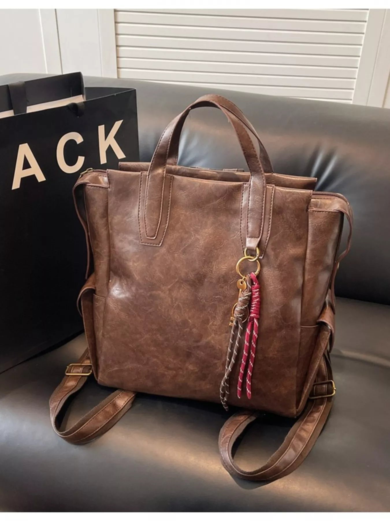 Vintage leather convertible backpack bag by Trendsi, showcasing a stylish brown leather backpack with adjustable straps and classic design.