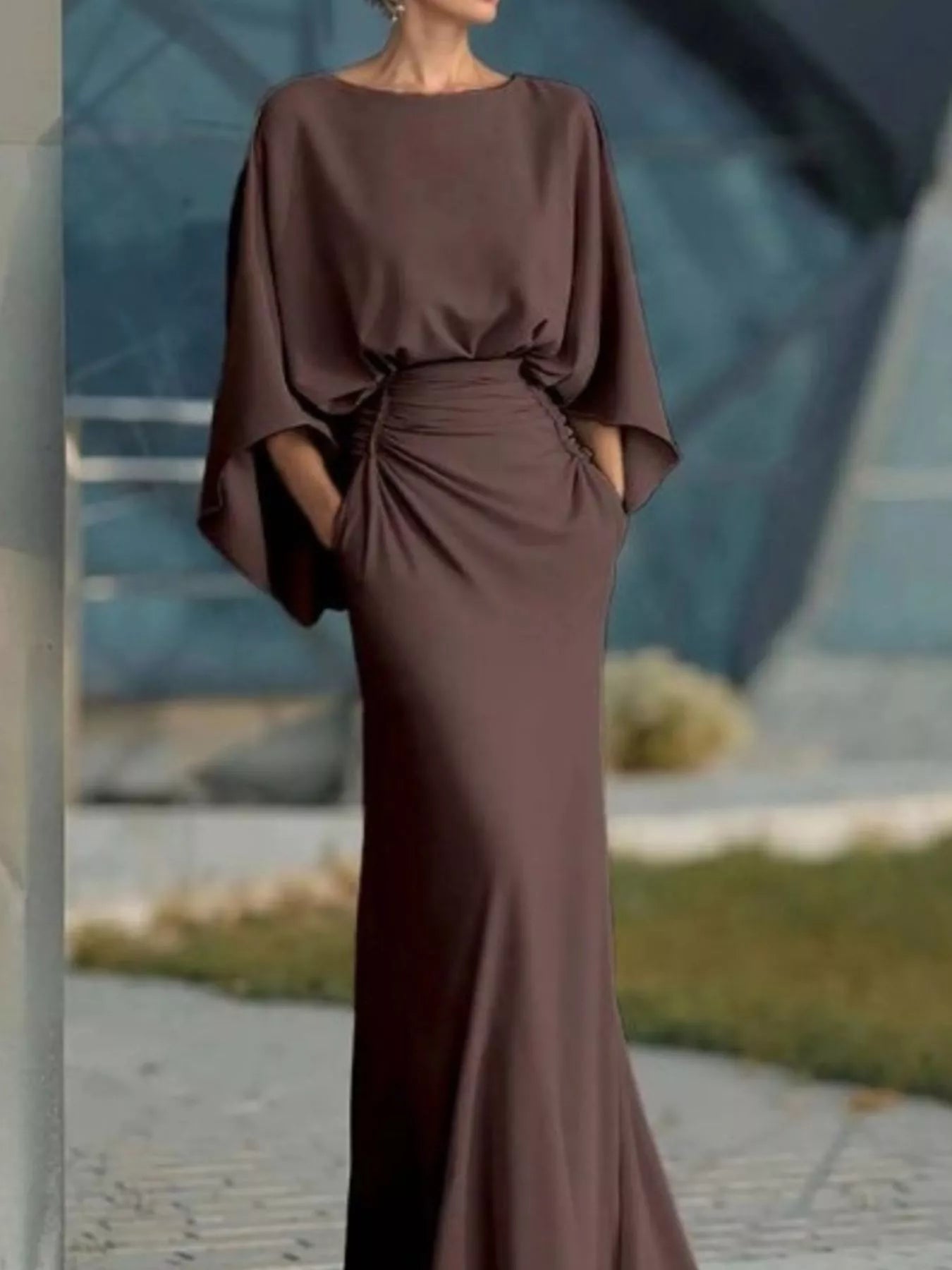 Batwing sleeve ruched evening dress by Trendsi featuring elegant draped fabric and a fitted silhouette.