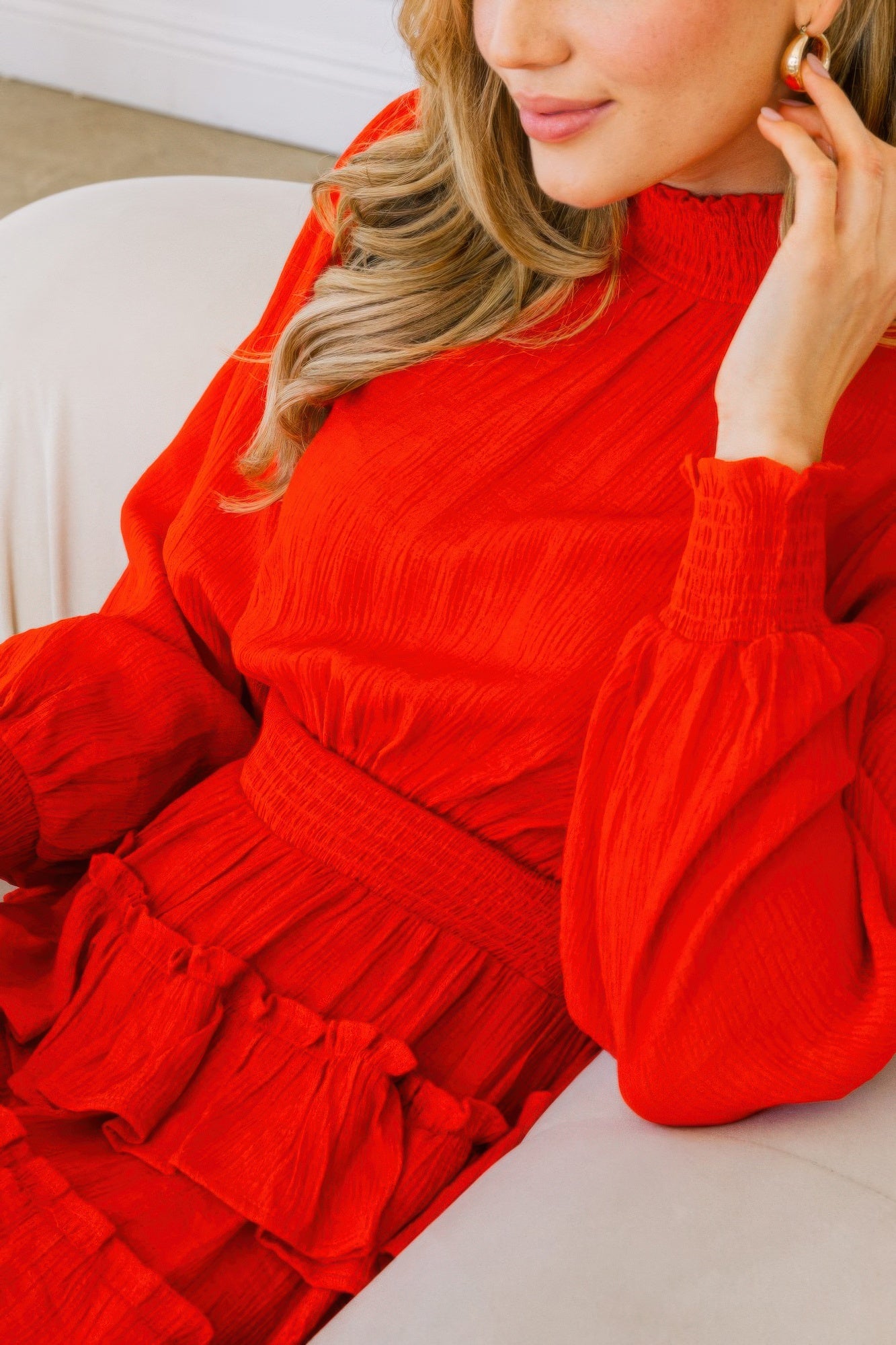 Toshe Women's Fashions smocked neck tiered ruffle mini dress shown in a stylish, lightweight fabric with ruffle details and a smocked neckline.