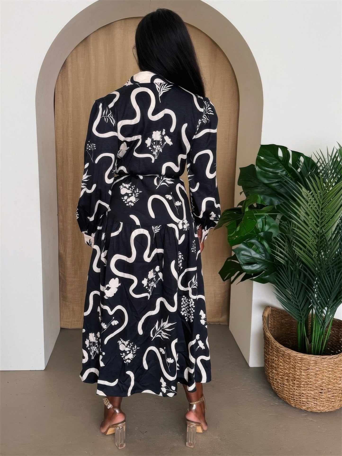 Toshe Women's Fashions Botanic Maze belted shirt dress with long sleeves and a floral pattern, hanging on a hanger.