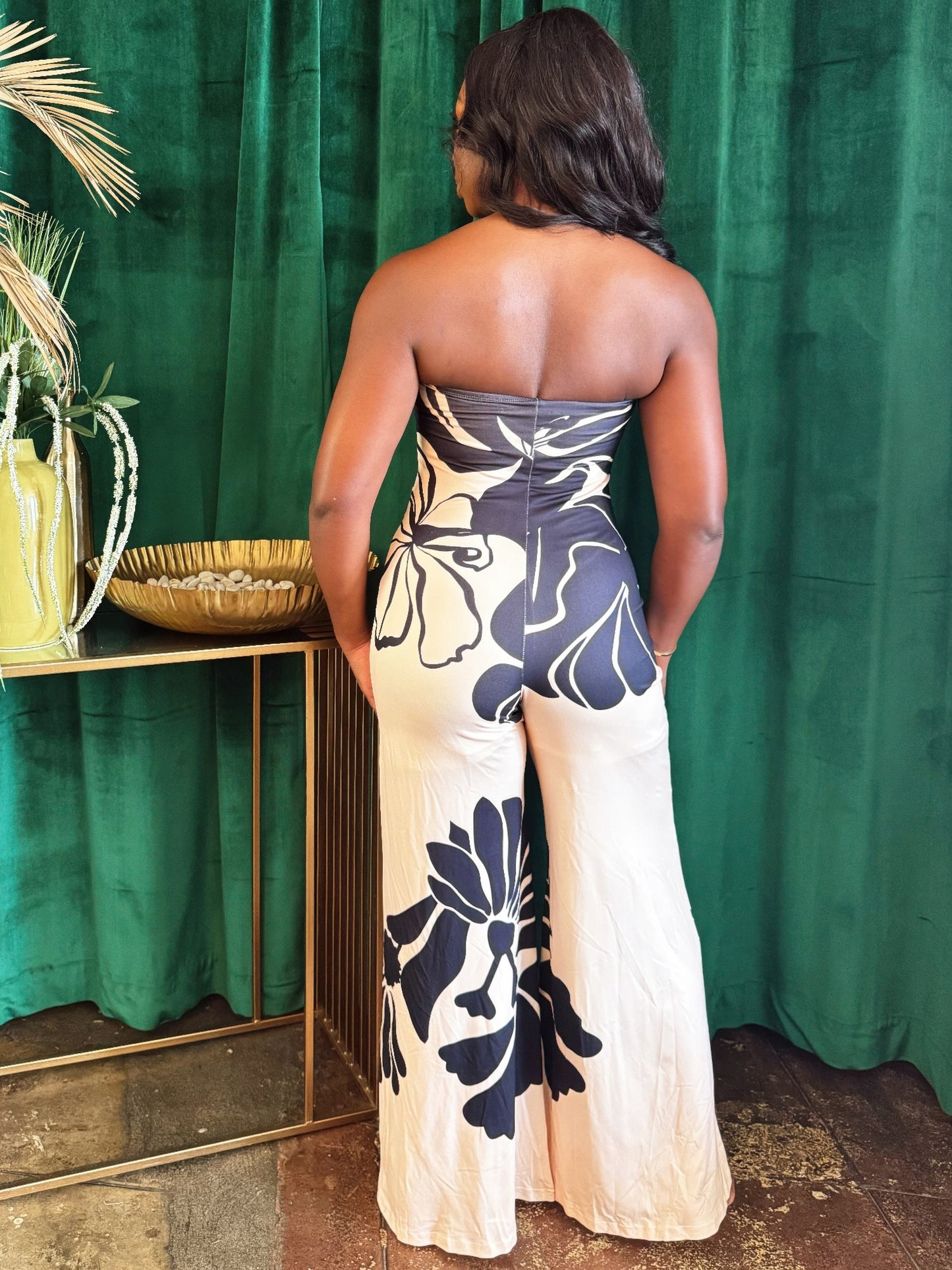 Midnight Bloom halter jumpsuit by Toshe Women's Fashions, featuring a fitted bodice and wide-leg pants, shown on a model.