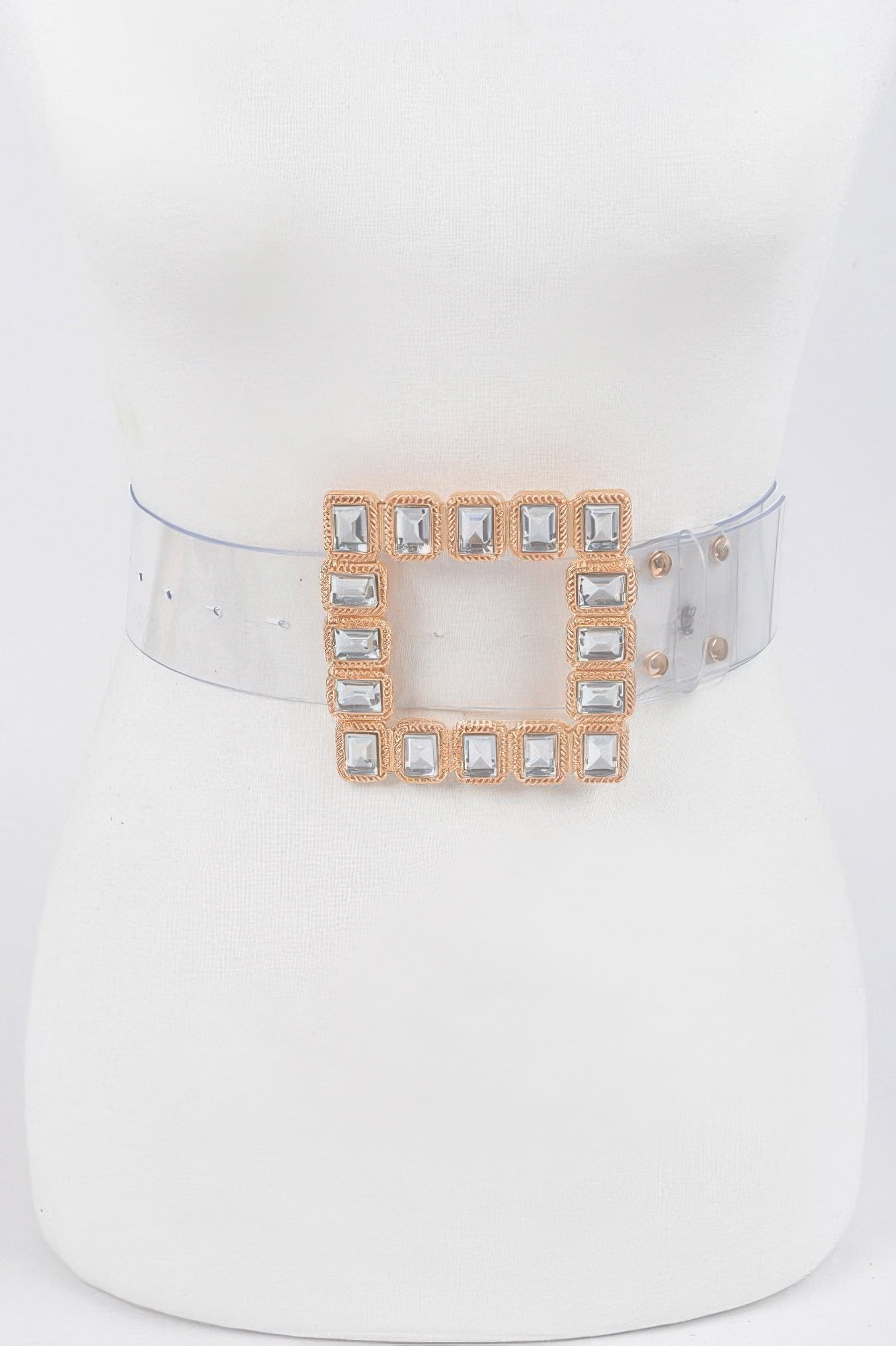 Transparent belt with stone buckle from Toshe Women's Fashions, showing clear strap and decorative stone detail.