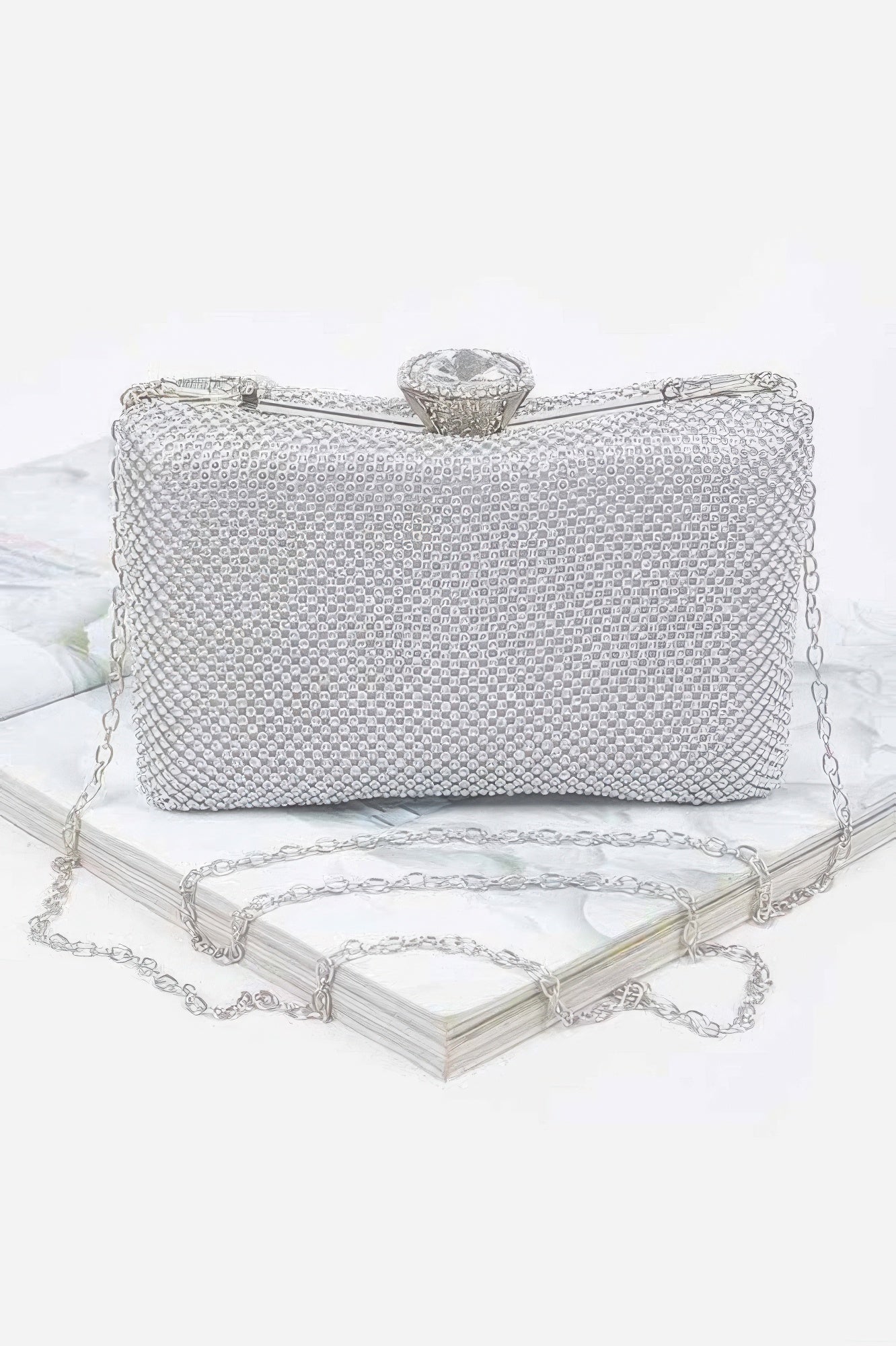 Shiny rhinestone hard clutch purse with silver clasp, elegant accessory for evening wear by Toshe Women's Fashions.