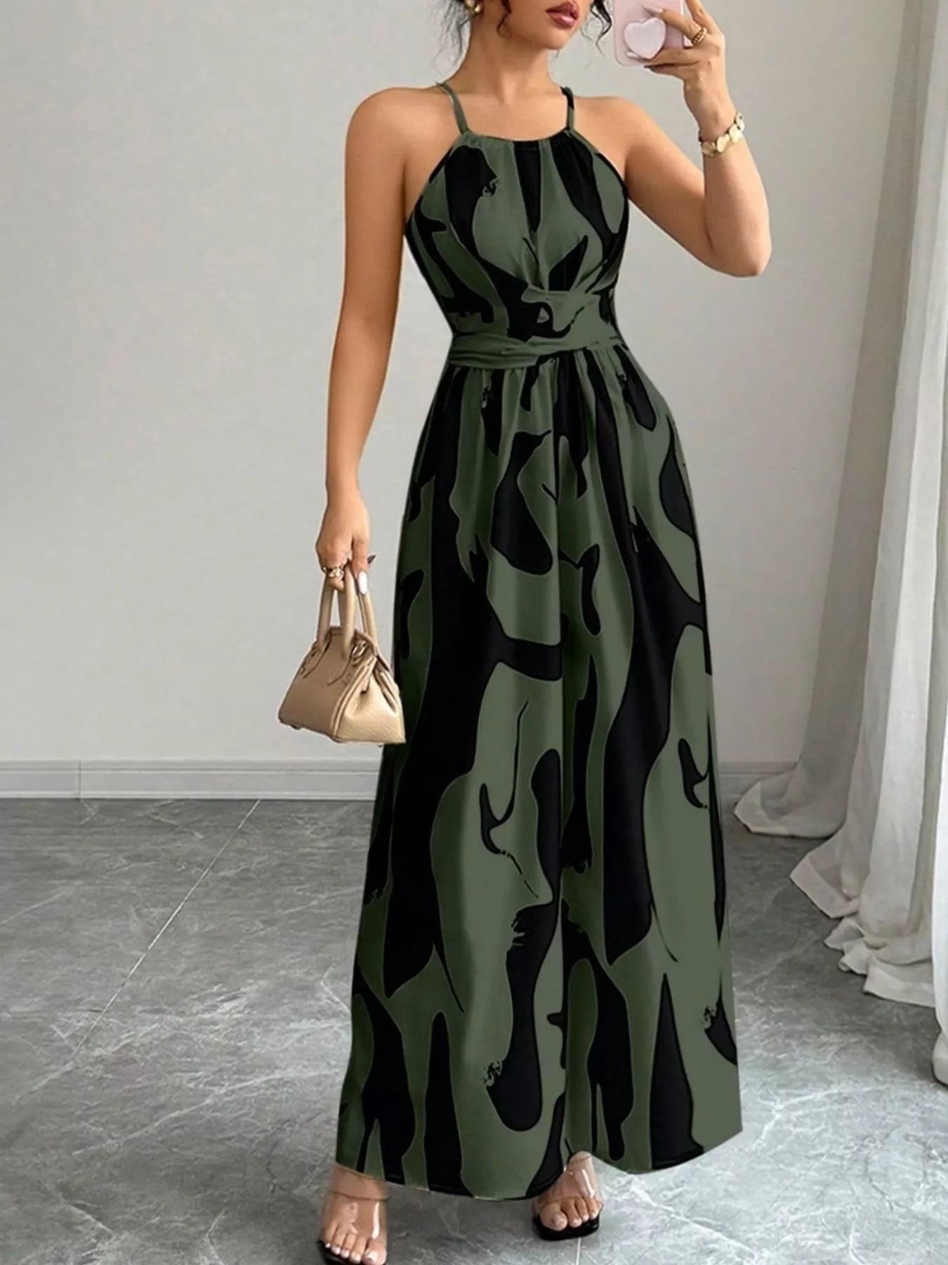 Abstract print halter neck maxi dress from Trendsi featuring a flowing silhouette and vibrant, artistic design.