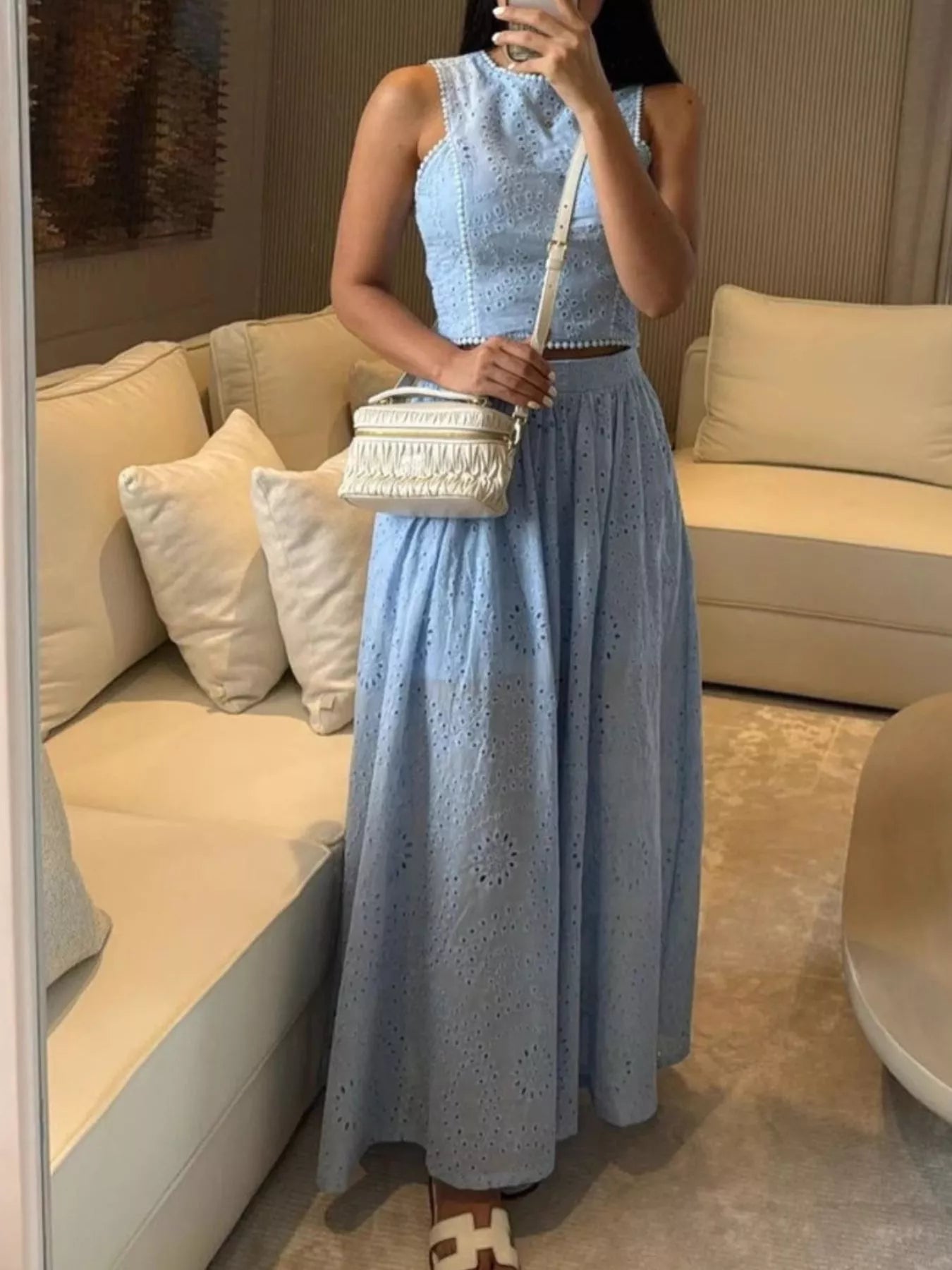 Trendsi eyelet crop top and maxi skirt set, matching outfit with eyelet fabric, seen on a model in a stylish pose.