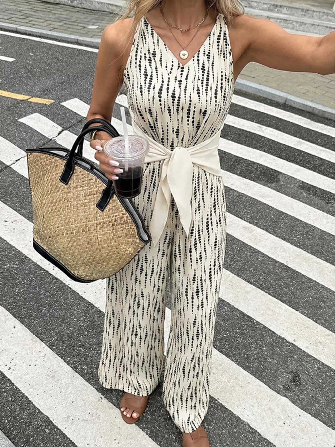 Printed wide-leg jumpsuit from Trendsi featuring a stylish design, with a relaxed fit and bold pattern, perfect for casual or dressy occasions.
