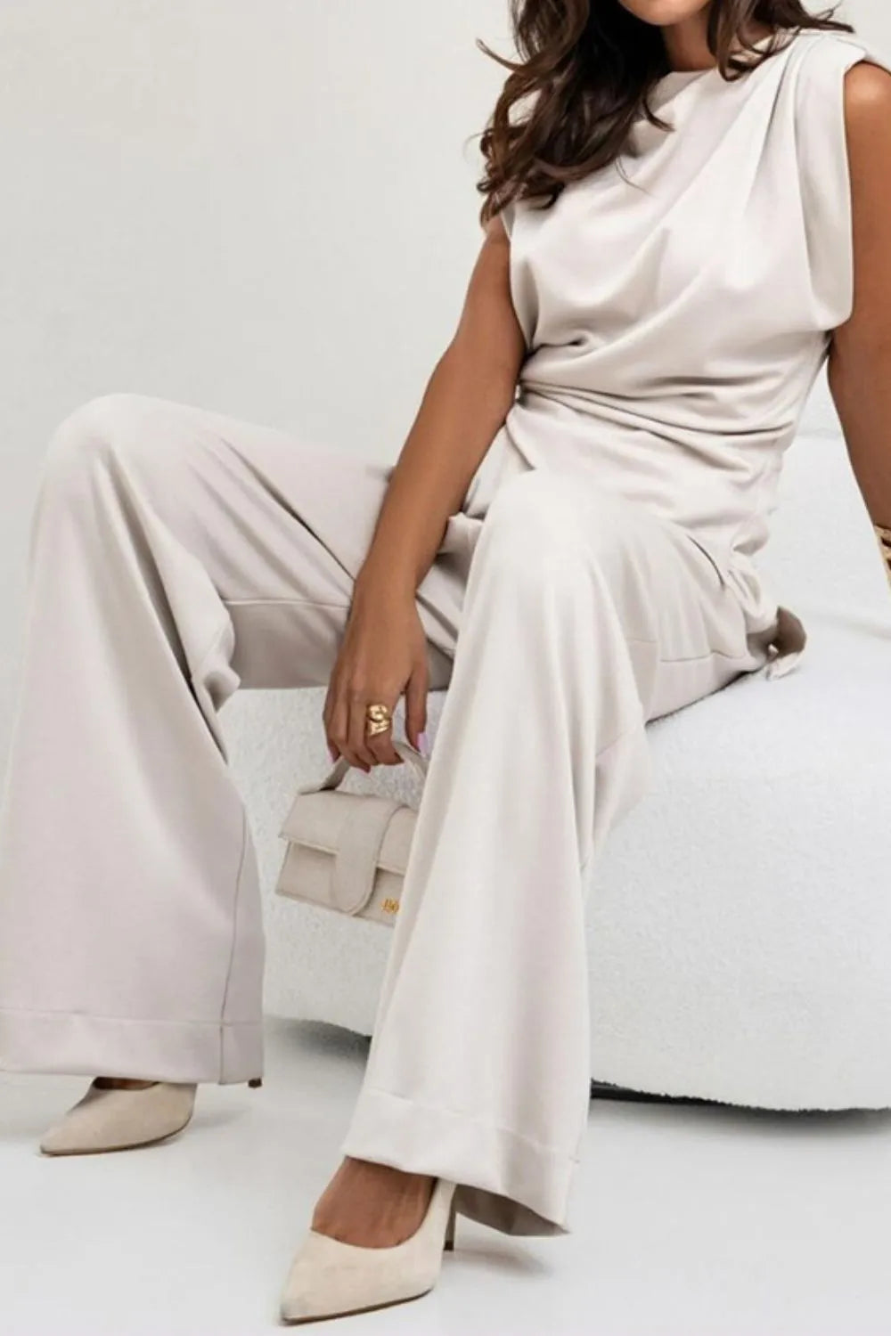 Draped sleeveless asymmetric top and matching pants set by Trendsi, stylish modern outfit with flowing fabric and unique design details.