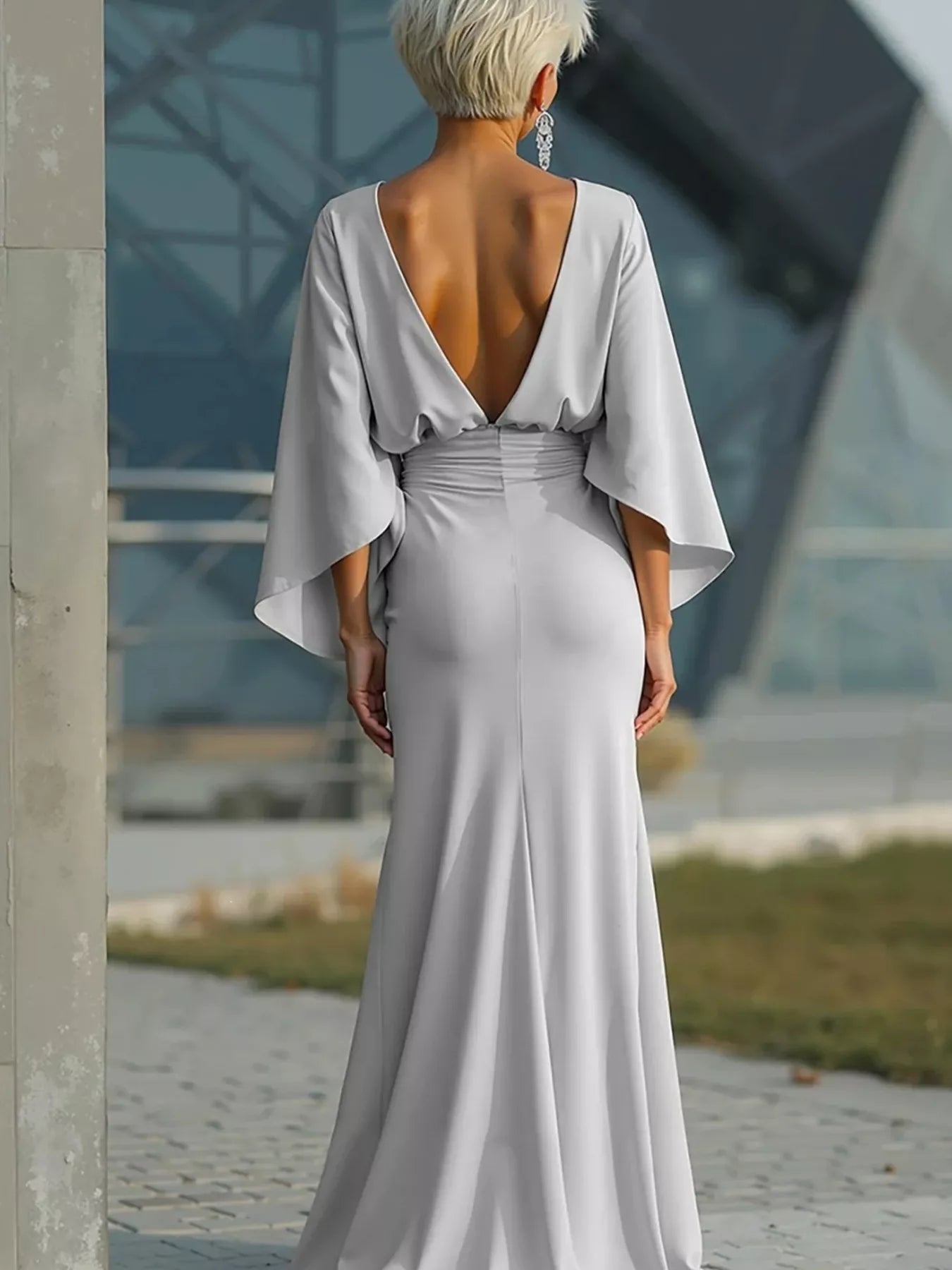 Elegant black batwing sleeve ruched evening dress by Trendsi, featuring a flattering fit and stylish design.