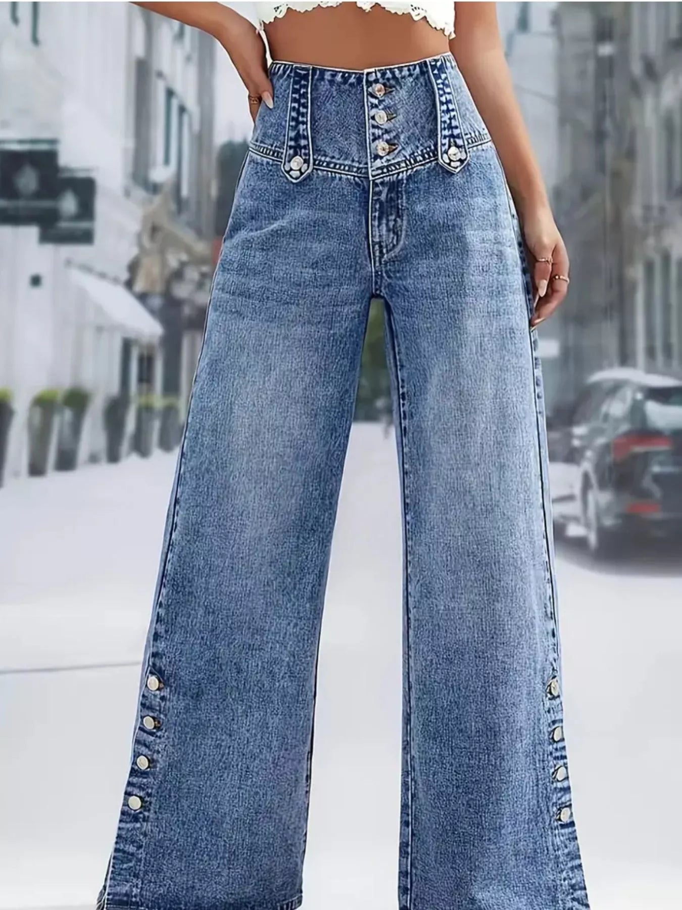 High waist denim jeans with button decor and wide-leg style, trendy fashion by Trendsi, shown on a model.
