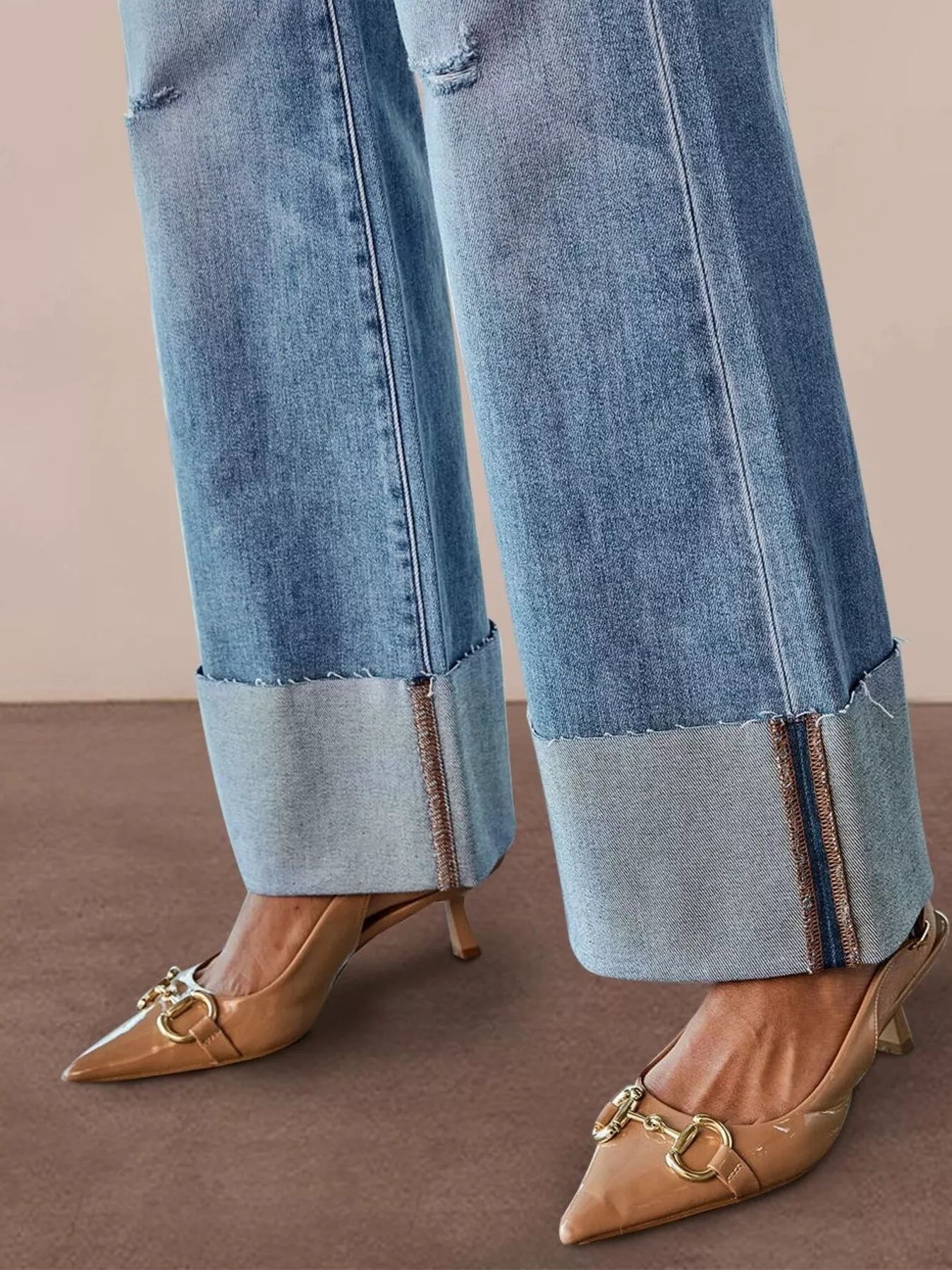 Distressed high-waisted flare denim jeans from Trendsi, featuring a vintage wash, ripped details, and a fitted silhouette.