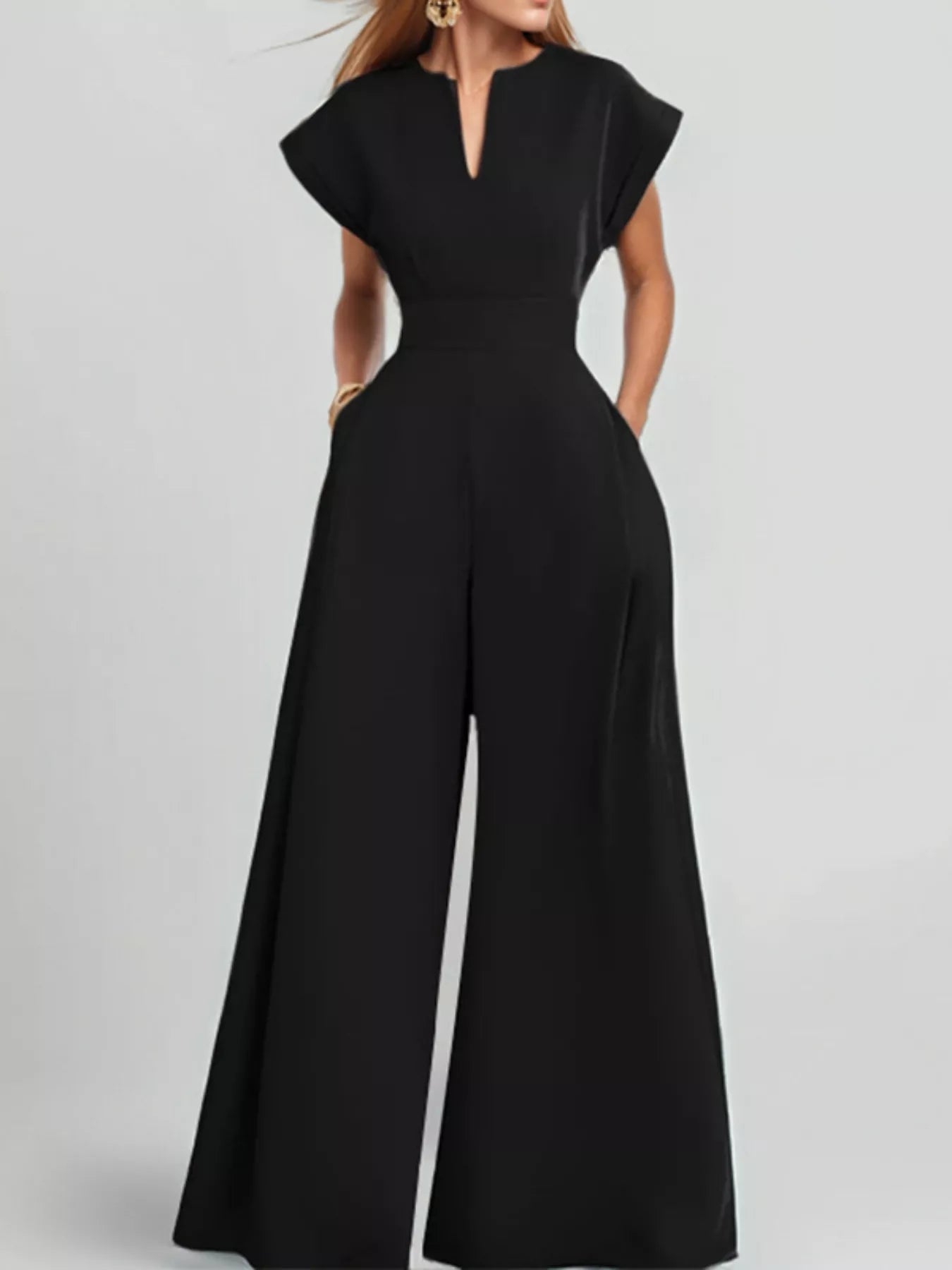 Notched wide-leg jumpsuit from Trendsi featuring a stylish design with a fitted waist and flowy leg openings.