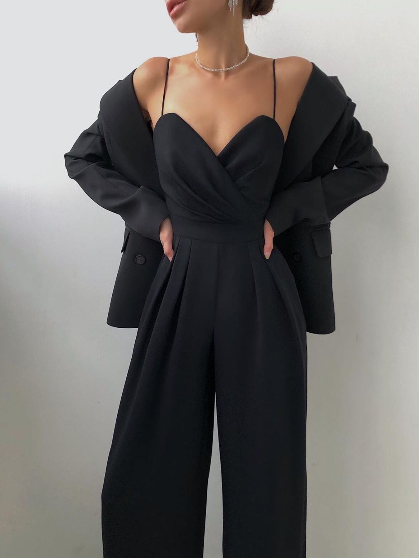 Trendsi spaghetti strap wide-leg jumpsuit with flowing fabric and stylish design, perfect for casual or dressy occasions.