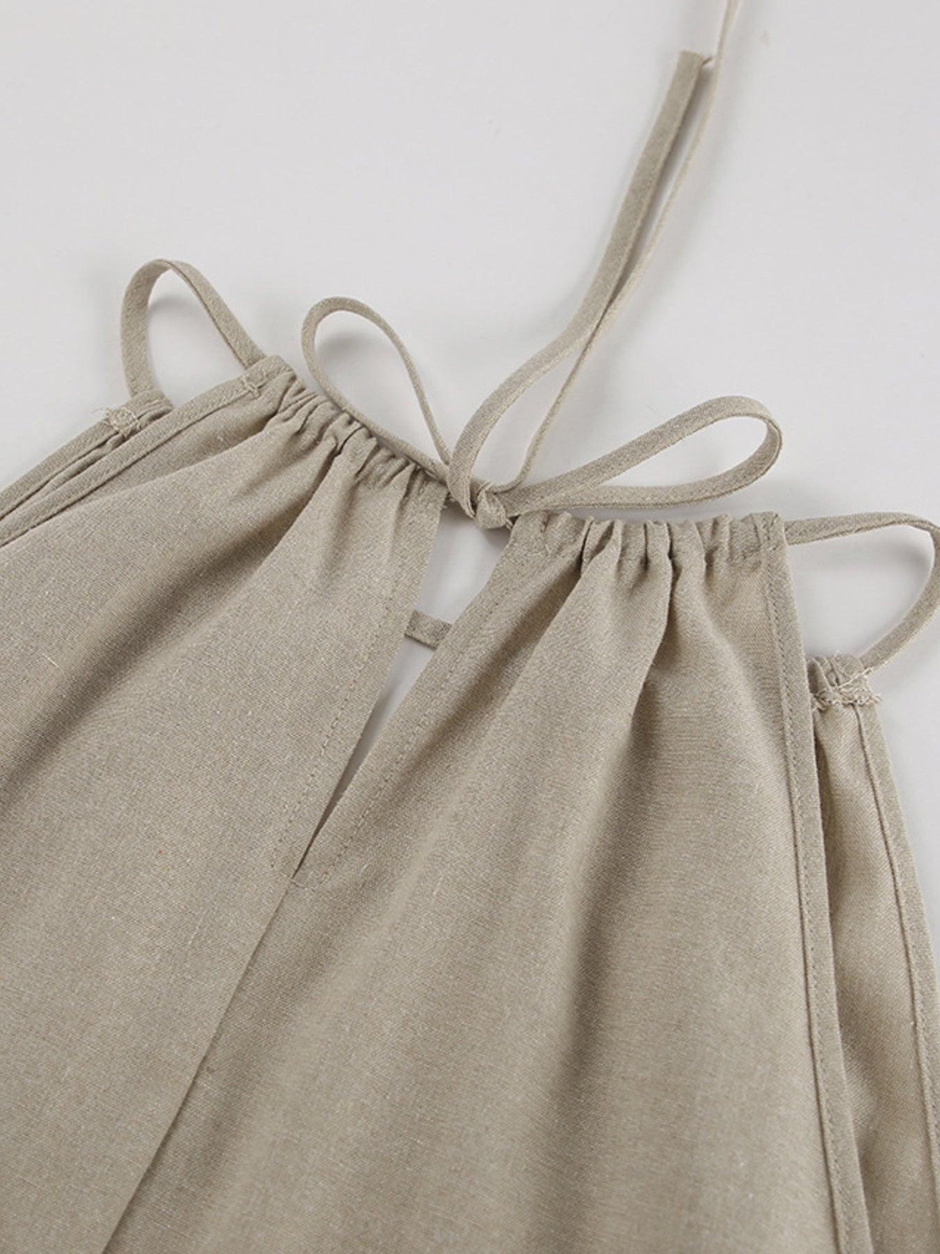 Trendsi cutout tank and wide-leg pants set featuring a sleeveless top with cutout details and flowy, high-waisted wide-leg pants.
