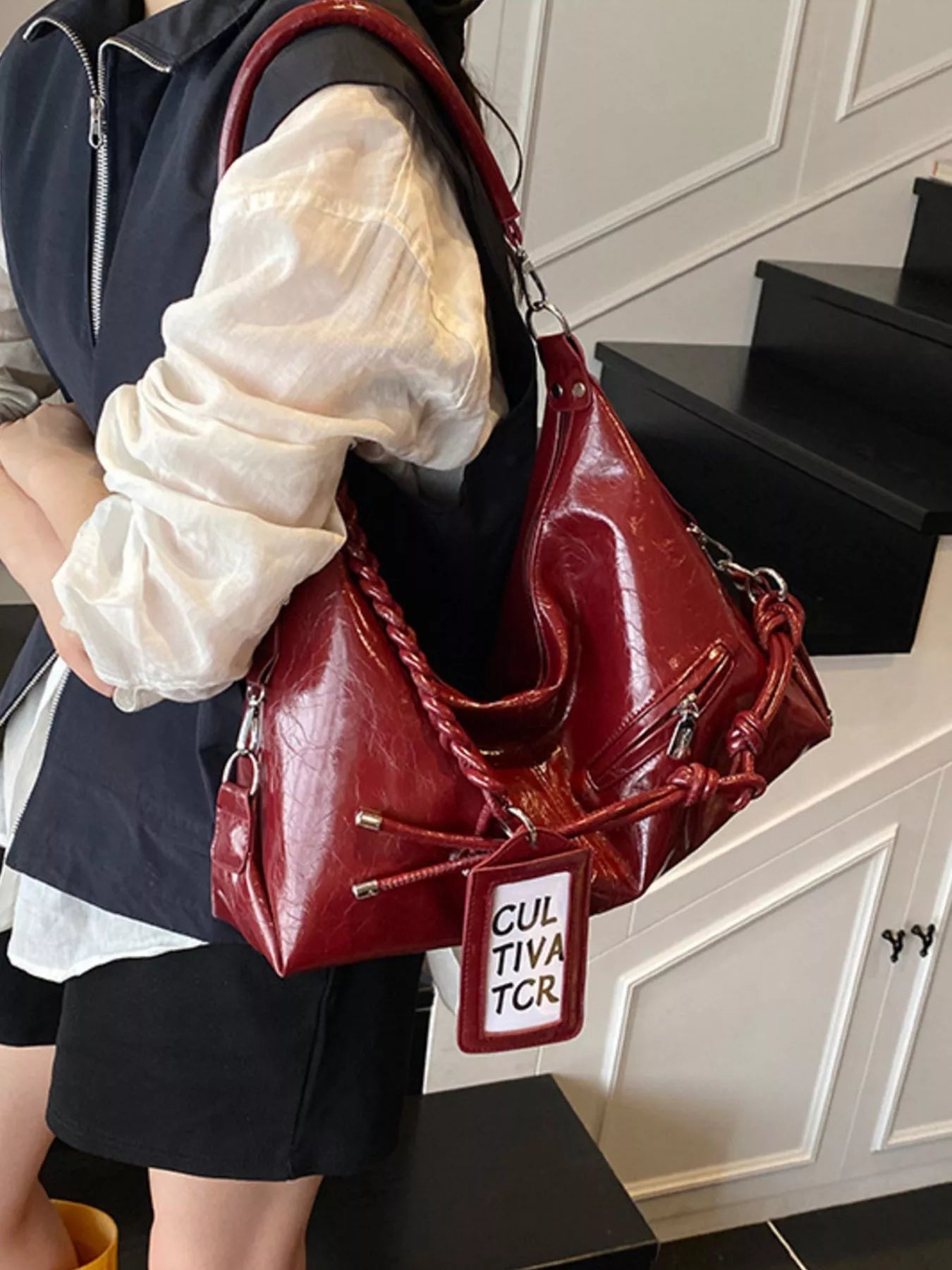Vintage braided strap shoulder handbag with woven detailing and adjustable shoulder strap, trendy Trendsi accessory.