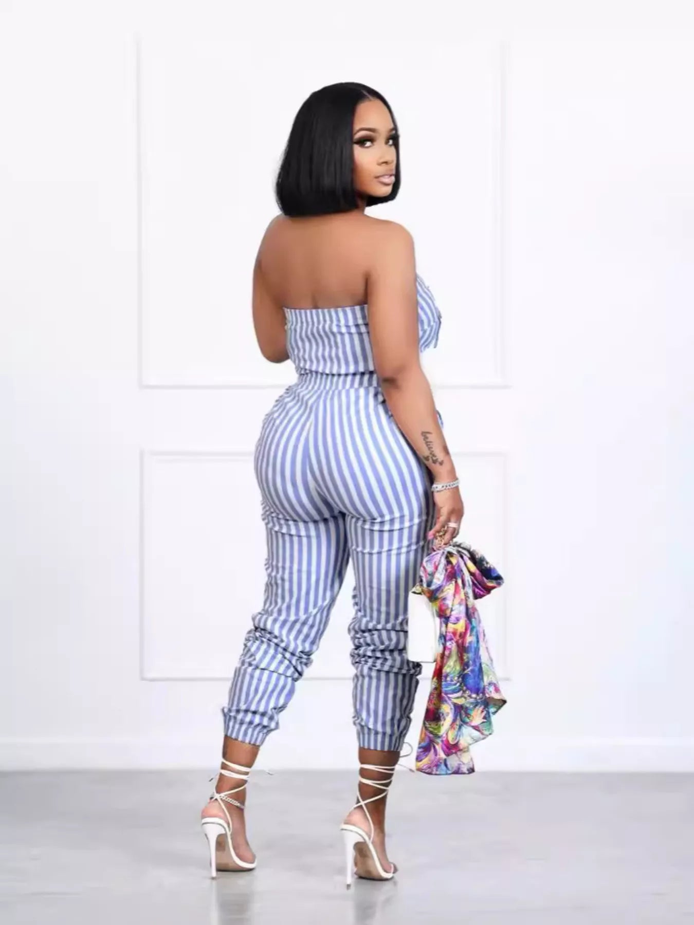 Striped tube jumpsuit from Trendsi featuring a fitted design with bold horizontal stripes and sleeveless style.