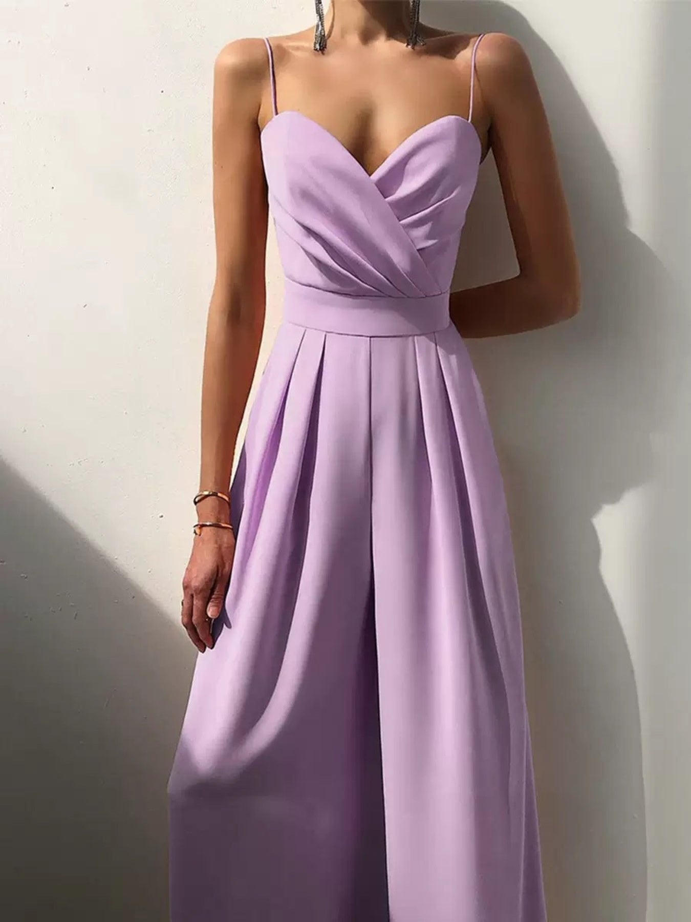 Light beige spaghetti strap wide leg jumpsuit by Trendsi, featuring a fitted bodice and flowing wide-leg pants.