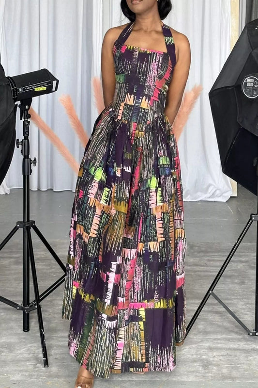 Abstract print halter neck maxi dress by Trendsi featuring a flowing design and vibrant pattern, perfect for elegant summer occasions.