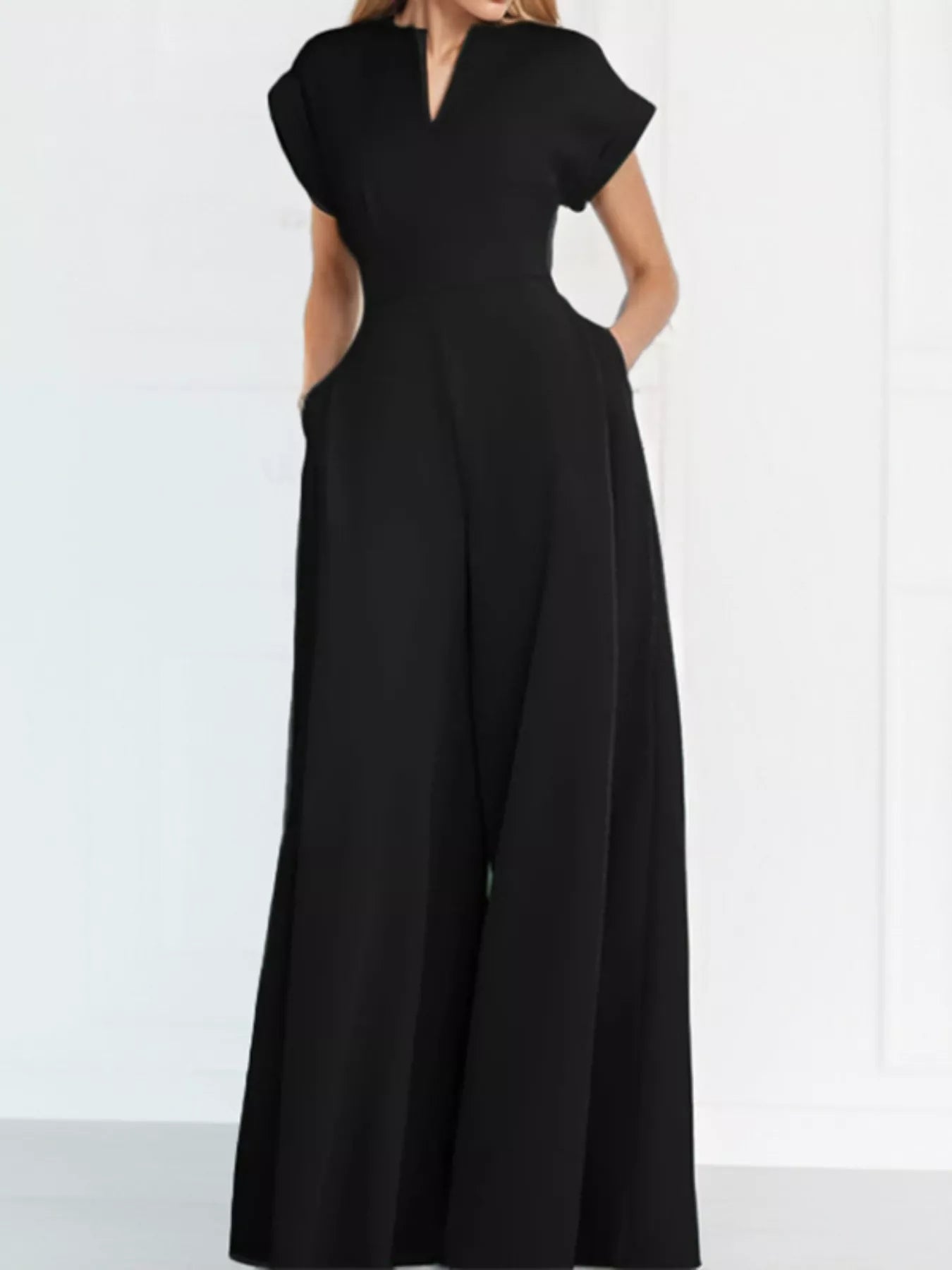 Notched wide-leg jumpsuit by Trendsi featuring a stylish design, with a fitted bodice and flowing wide-leg pants.
