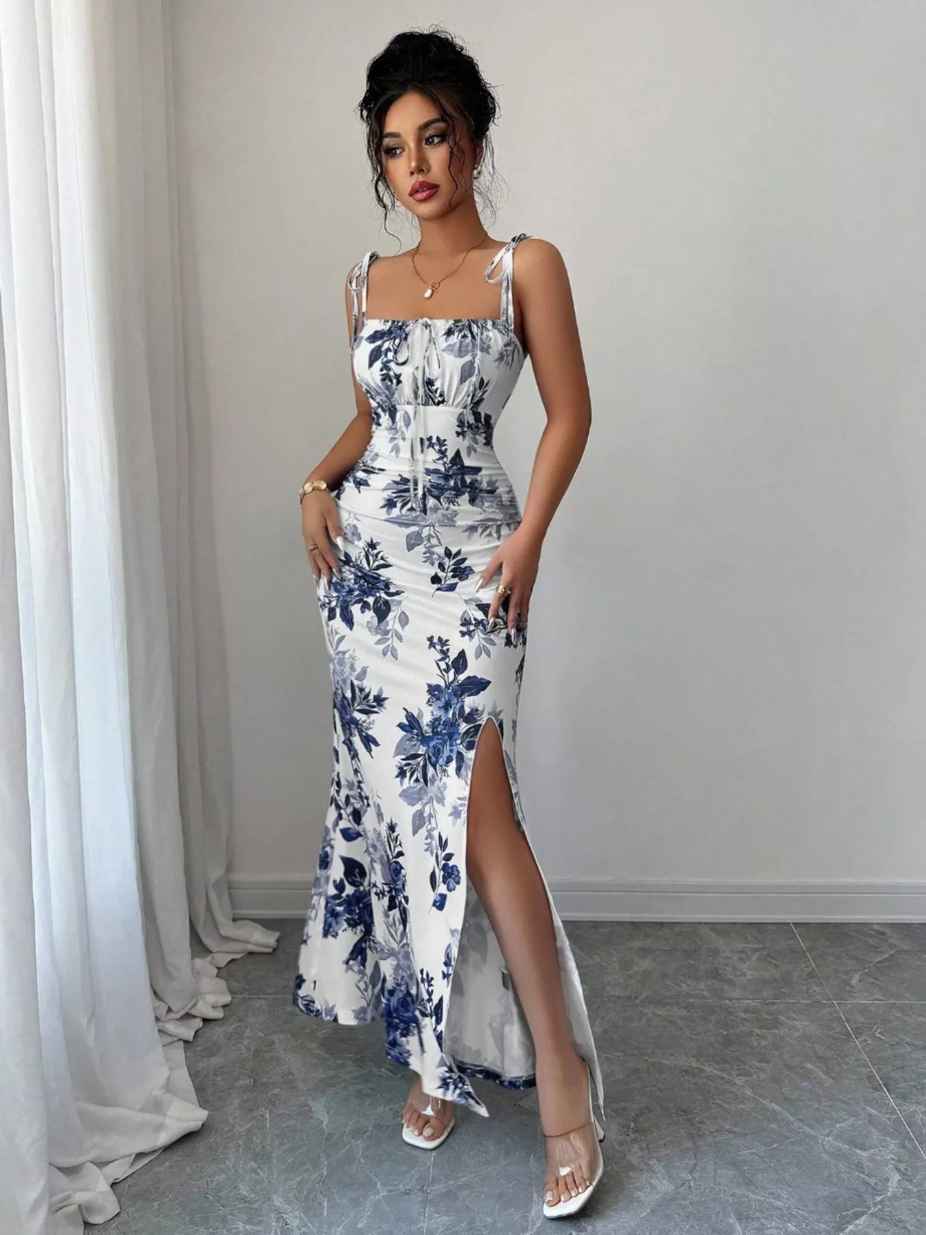 Printed tie strap slit maxi dress from Trendsi featuring a flowy silhouette, adjustable straps, and a side slit.