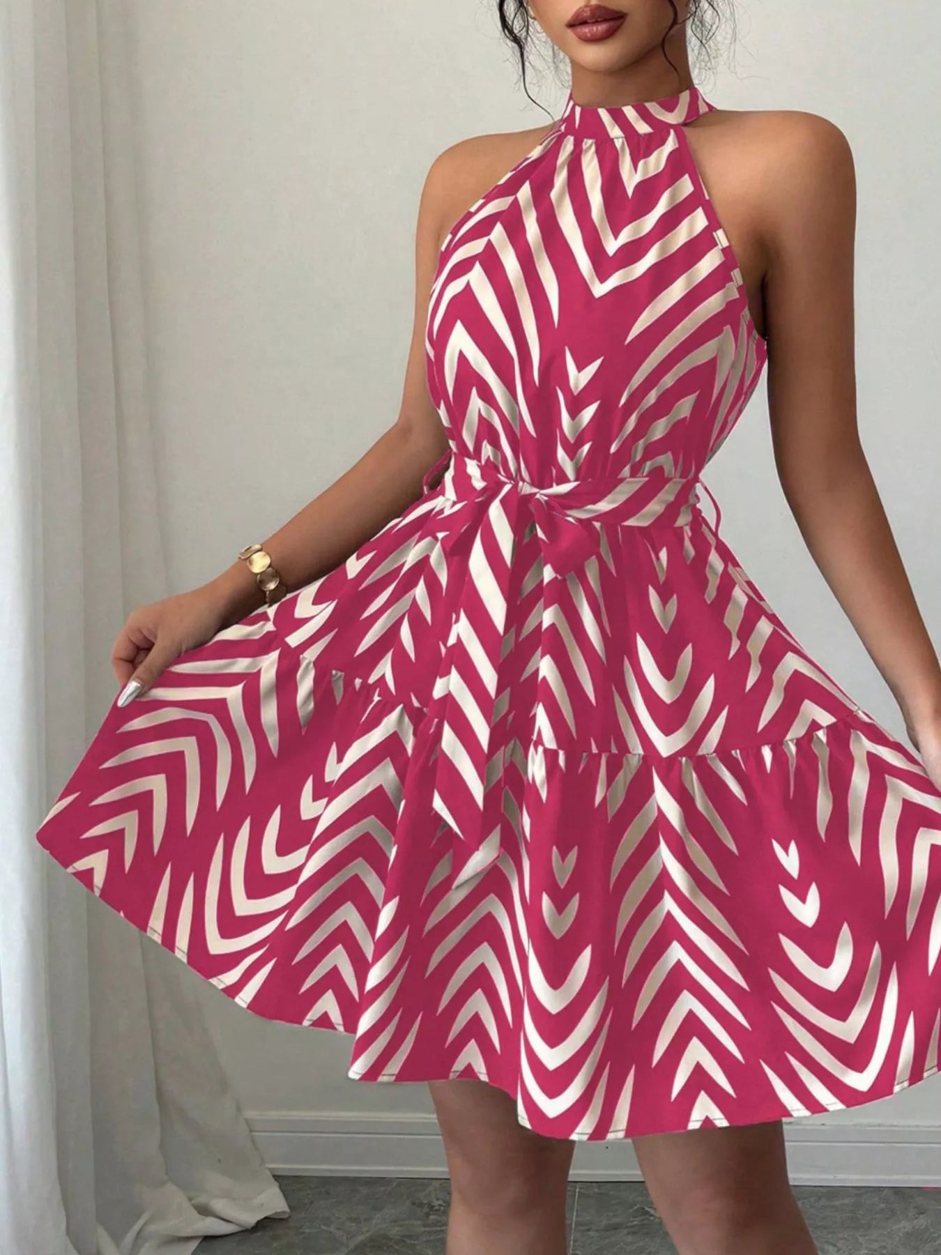 Zebra print halter neck dress with tie waist and ruffle hem, stylish dress by Trendsi displayed on a model.