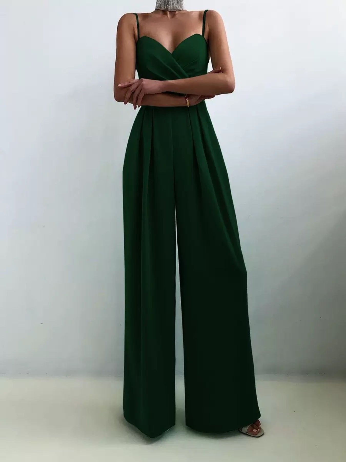White spaghetti strap wide-leg jumpsuit by Trendsi, featuring a sleeveless design and relaxed fit, perfect for casual or summer wear.