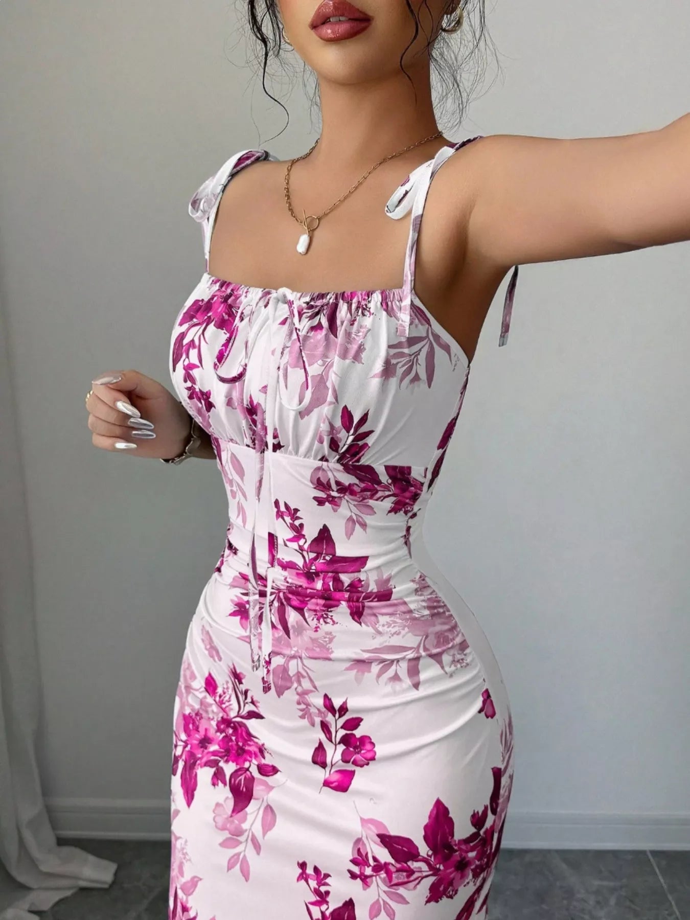 Printed tie strap slit maxi dress by Trendsi featuring a flowy silhouette, side slit, and adjustable tie straps.