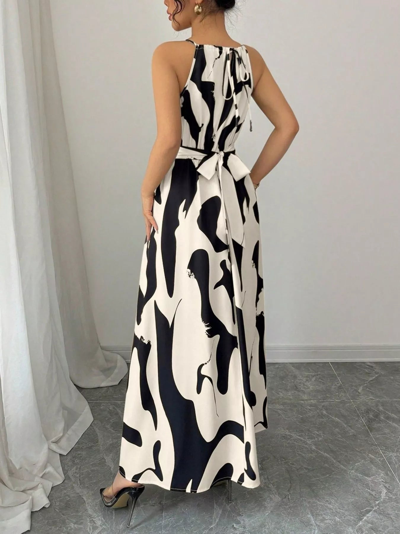 Abstract print halter neck maxi dress by Trendsi, flowing dress with bold patterns and a stylish halter neckline.