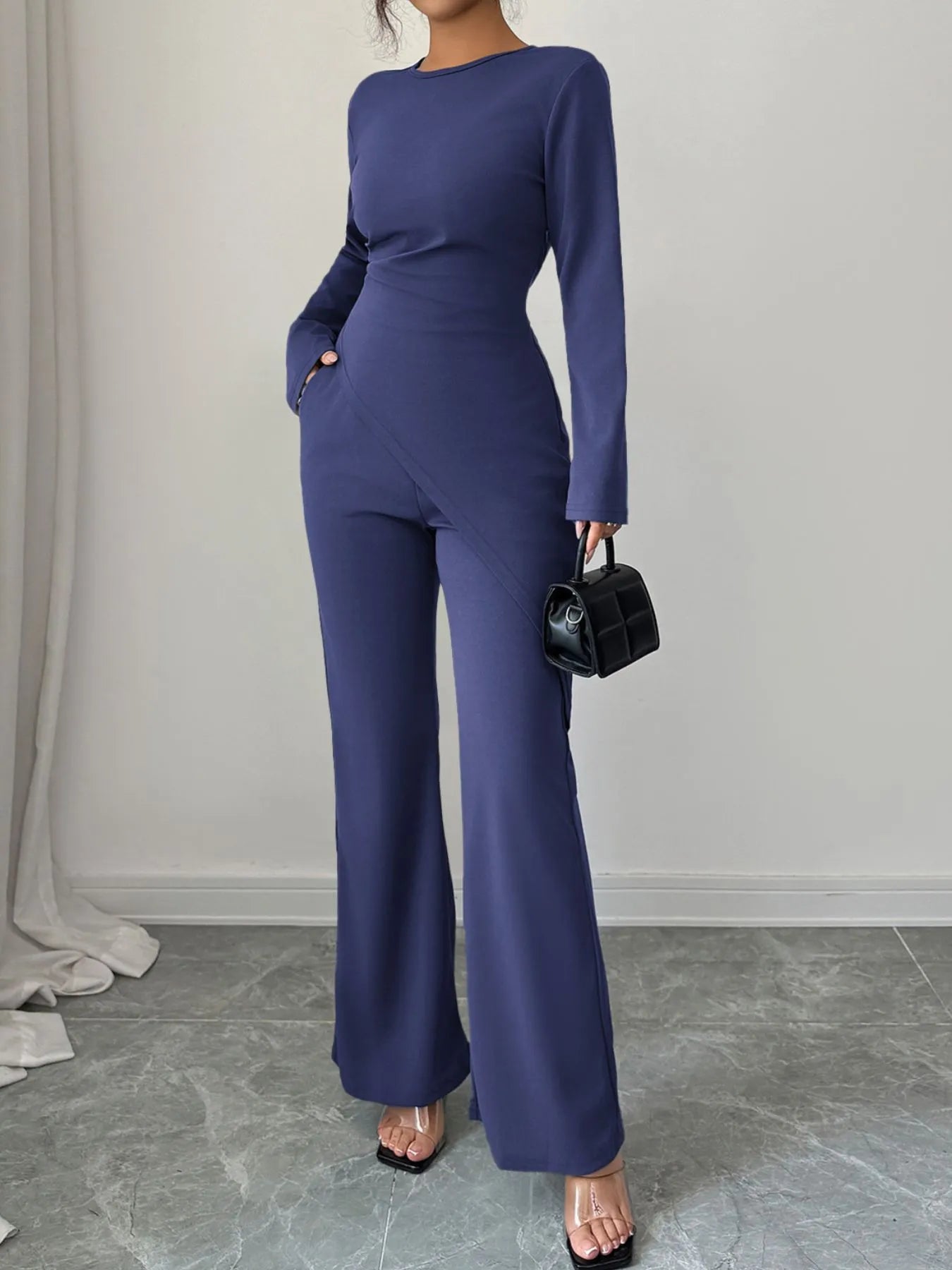 Asymmetric long sleeve top and pants set by Trendsi, featuring a stylish, modern design with contrasting fabric details.