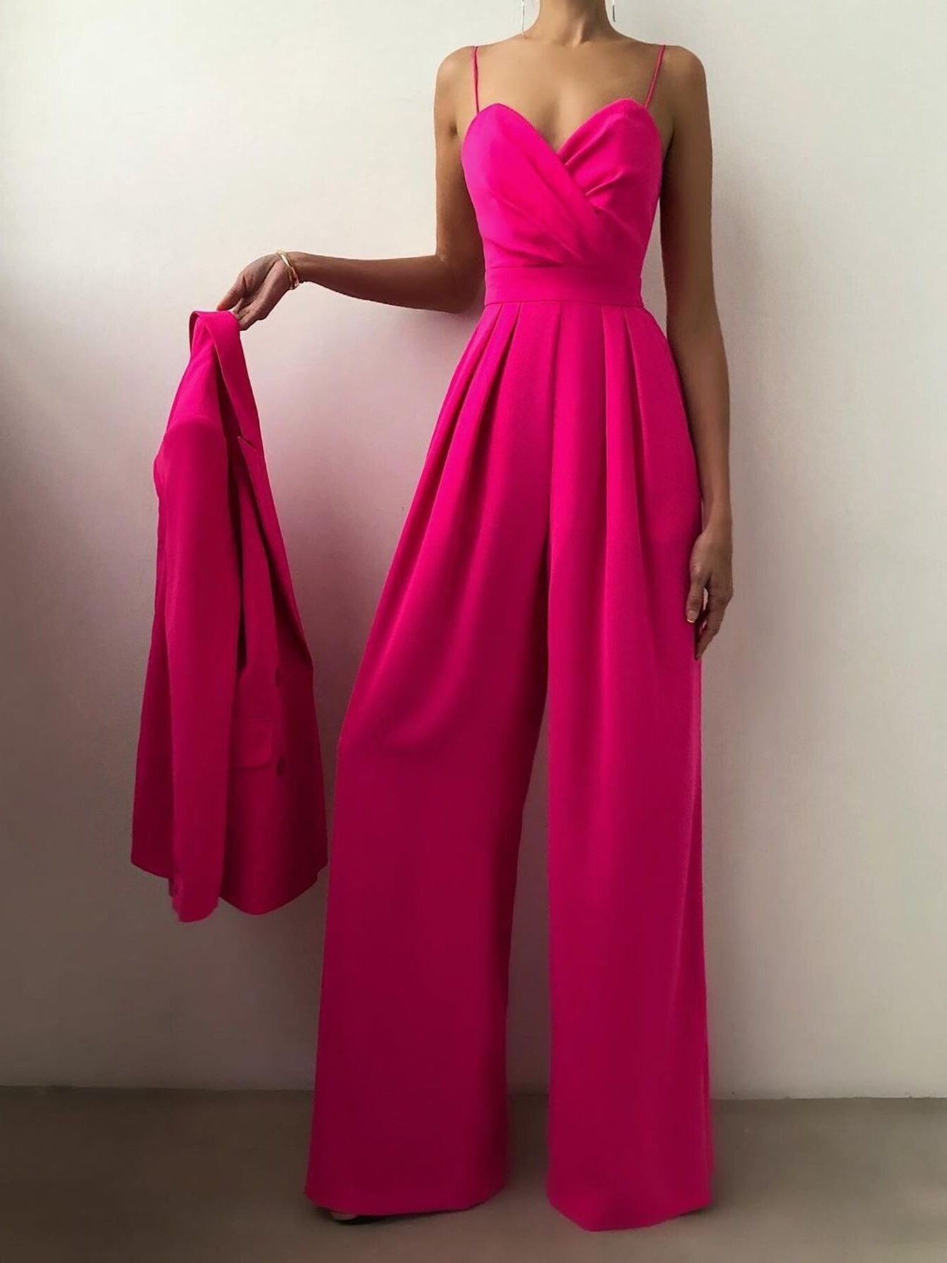 Black spaghetti strap wide-leg jumpsuit by Trendsi, featuring a fitted bodice and flowing wide-leg pants, casual and stylish.