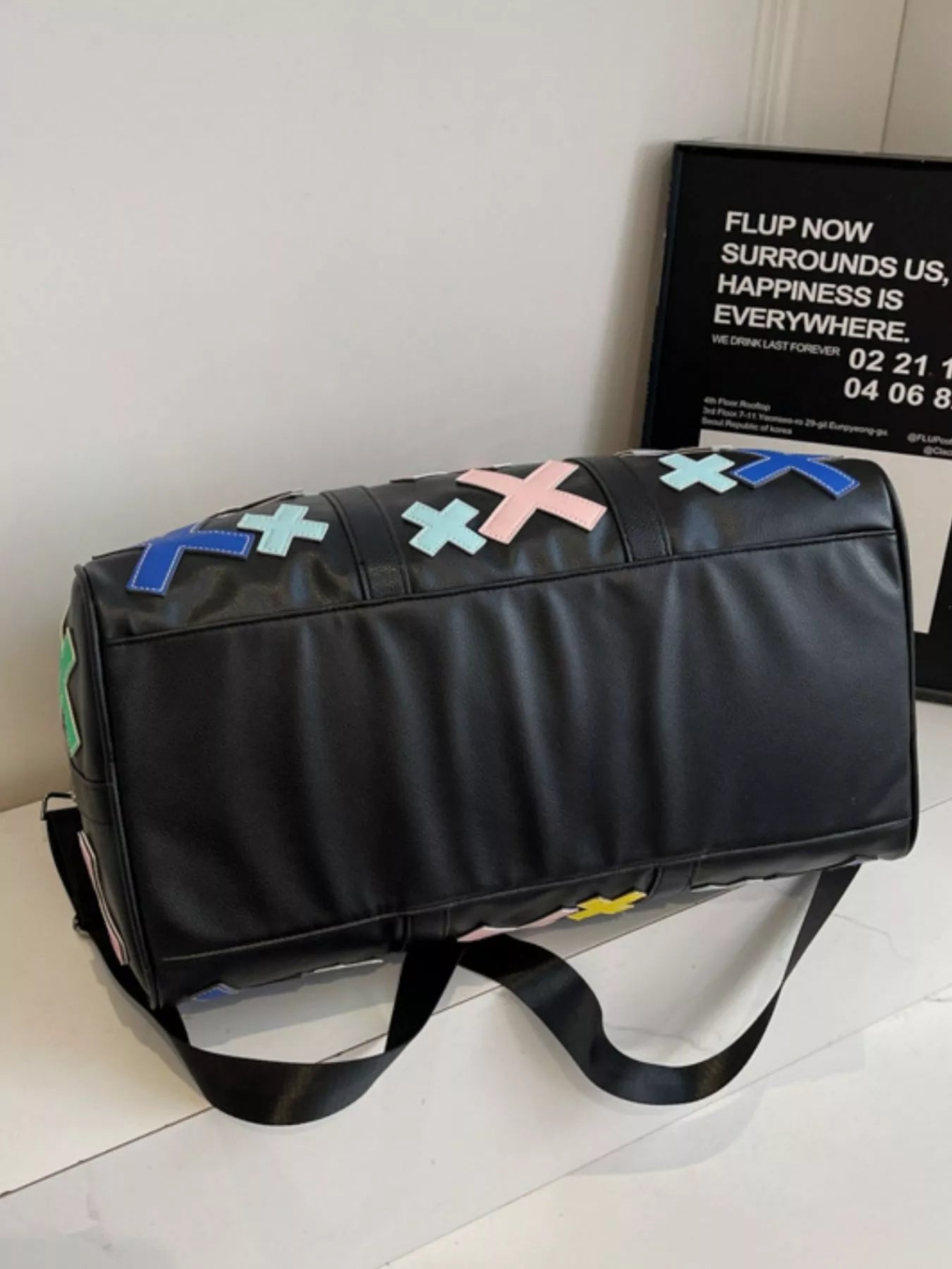 Colorful cross pattern travel duffel bag from Trendsi, showcasing vibrant fabric and sturdy handles for versatile hand-carry use.