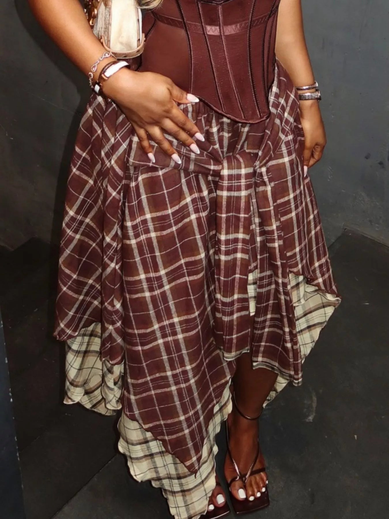Asymmetrical plaid skirt by Trendsi featuring a modern, stylish design with a mix of classic plaid pattern and uneven hem.