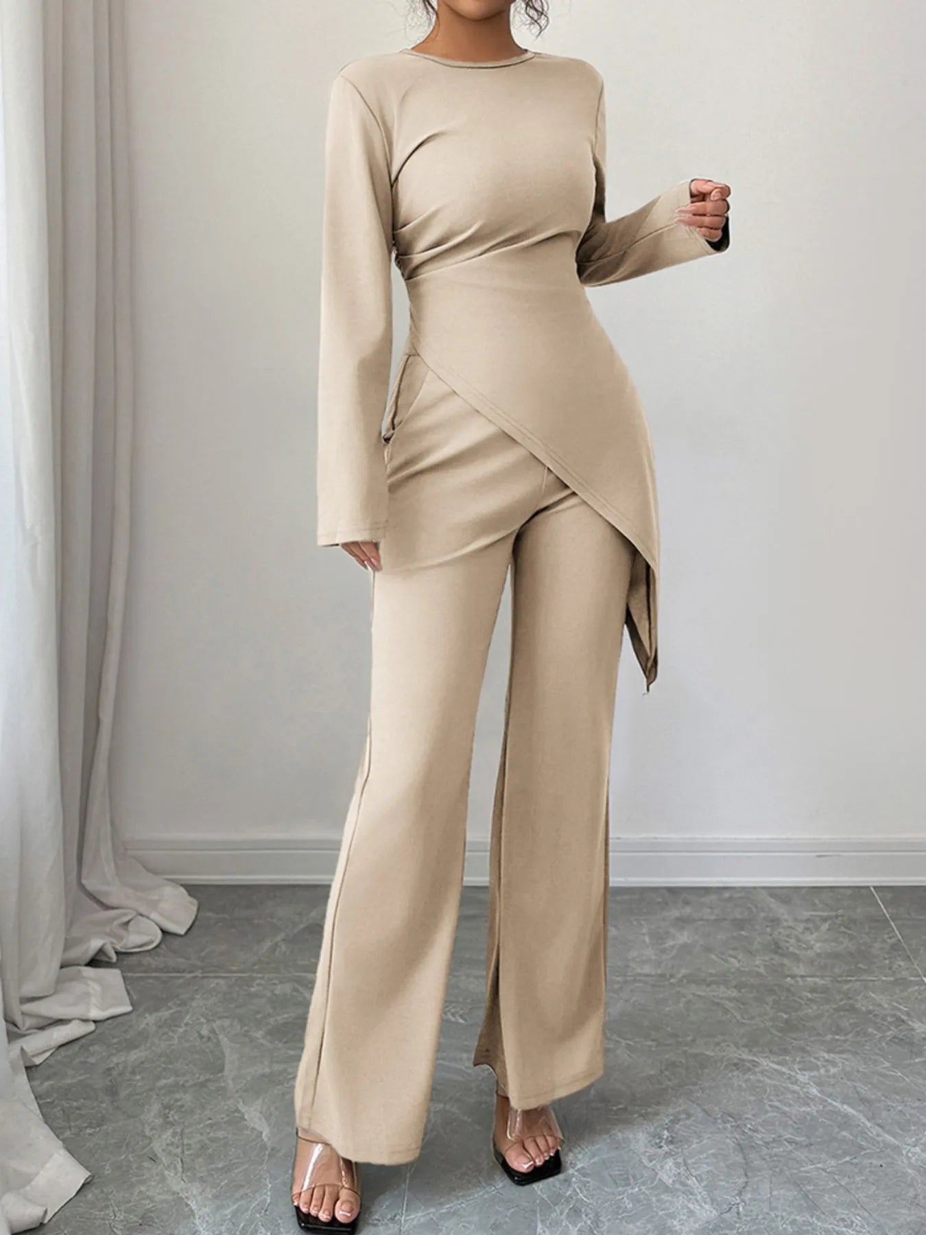 Asymmetric long sleeve top and matching pants set by Trendsi, stylish casual outfit with modern design and comfortable fit.