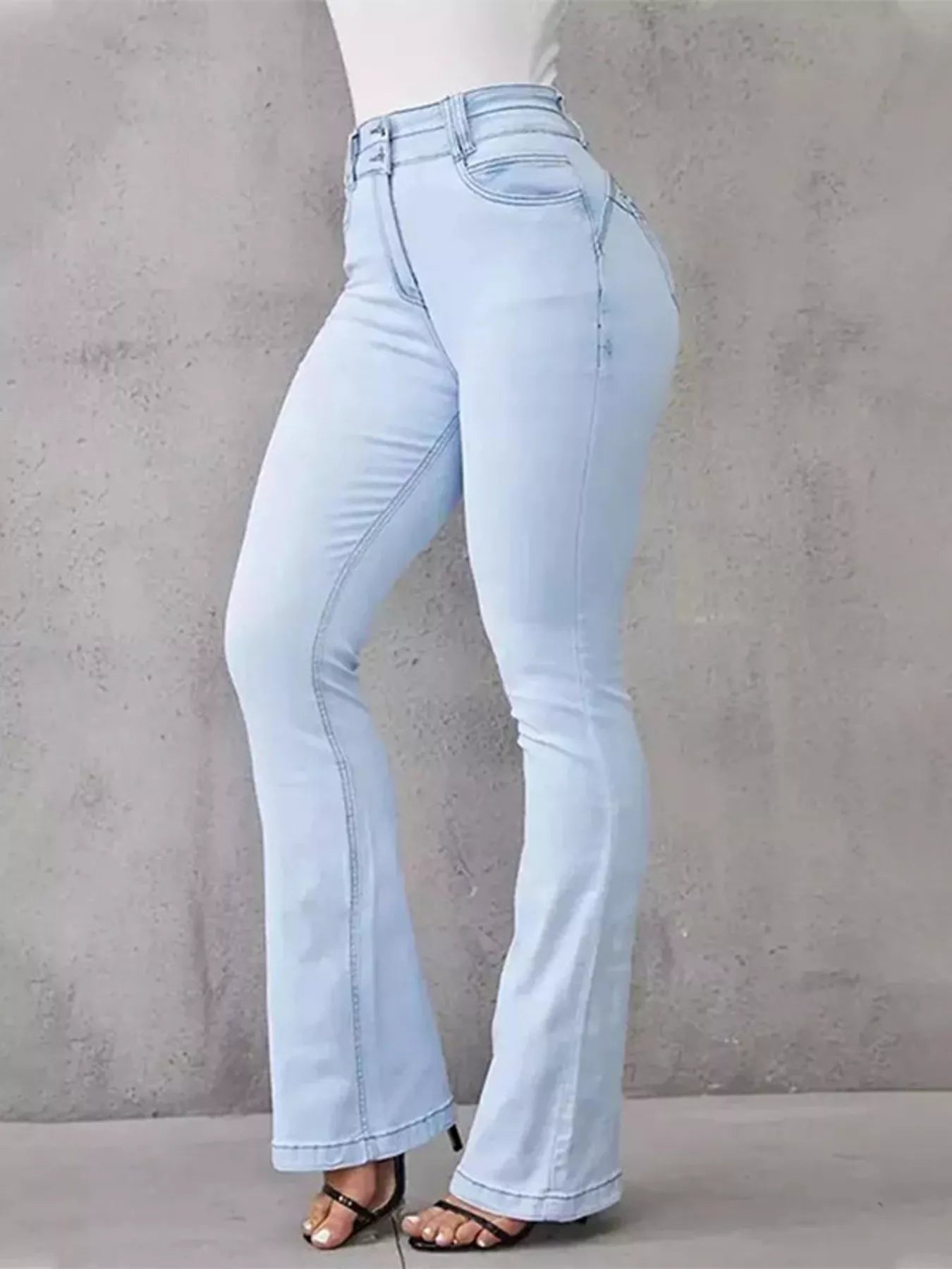 High-waisted flare jeans by Trendsi, showcasing their stylish fit and denim texture in a natural pose.