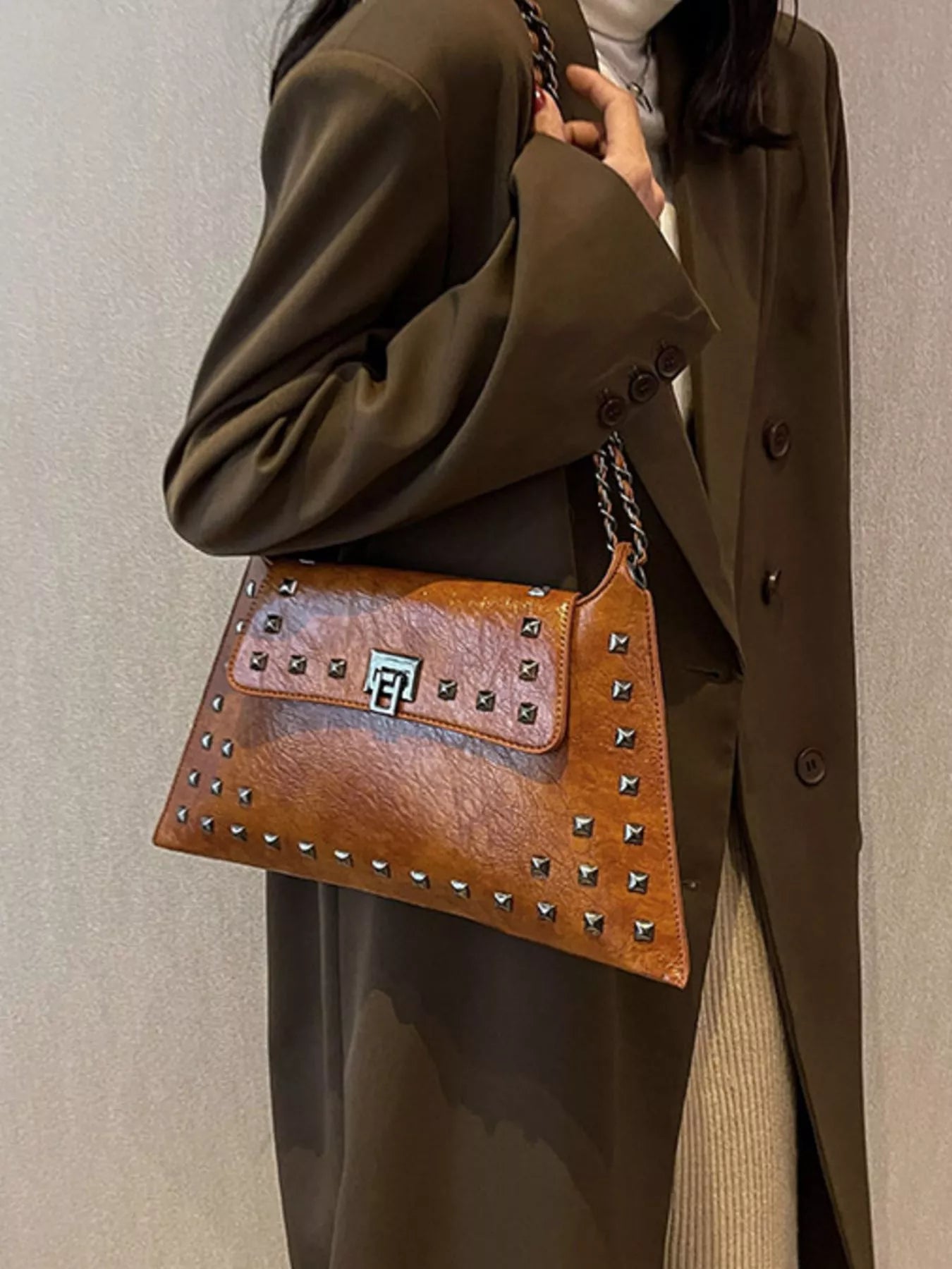 Studded flap chain shoulder handbag from Trendsi featuring a stylish design with metal chain strap and textured surface.