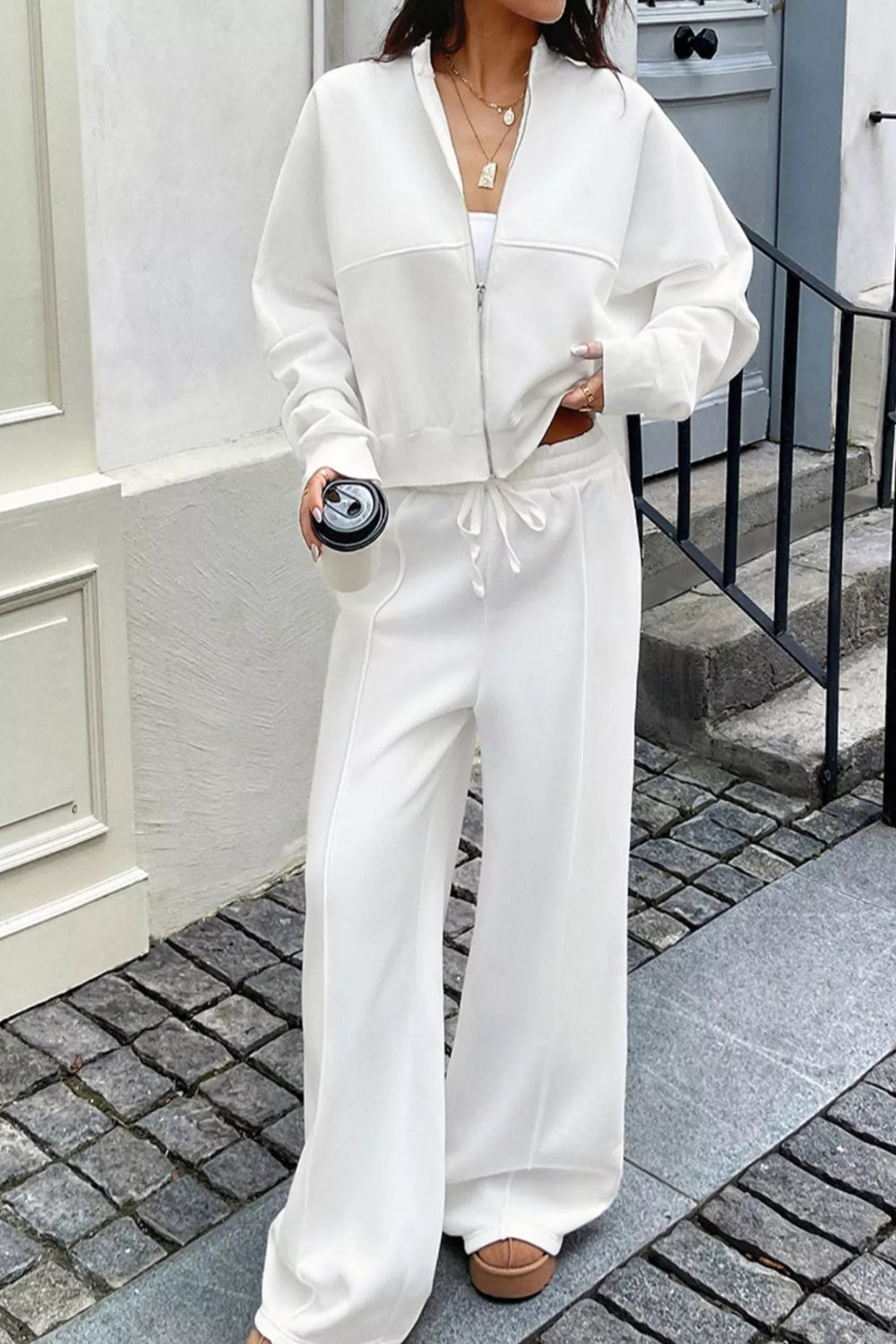 White zip-up jacket and pants set by Trendsi, featuring a casual, comfortable design with a front zipper and matching pants.