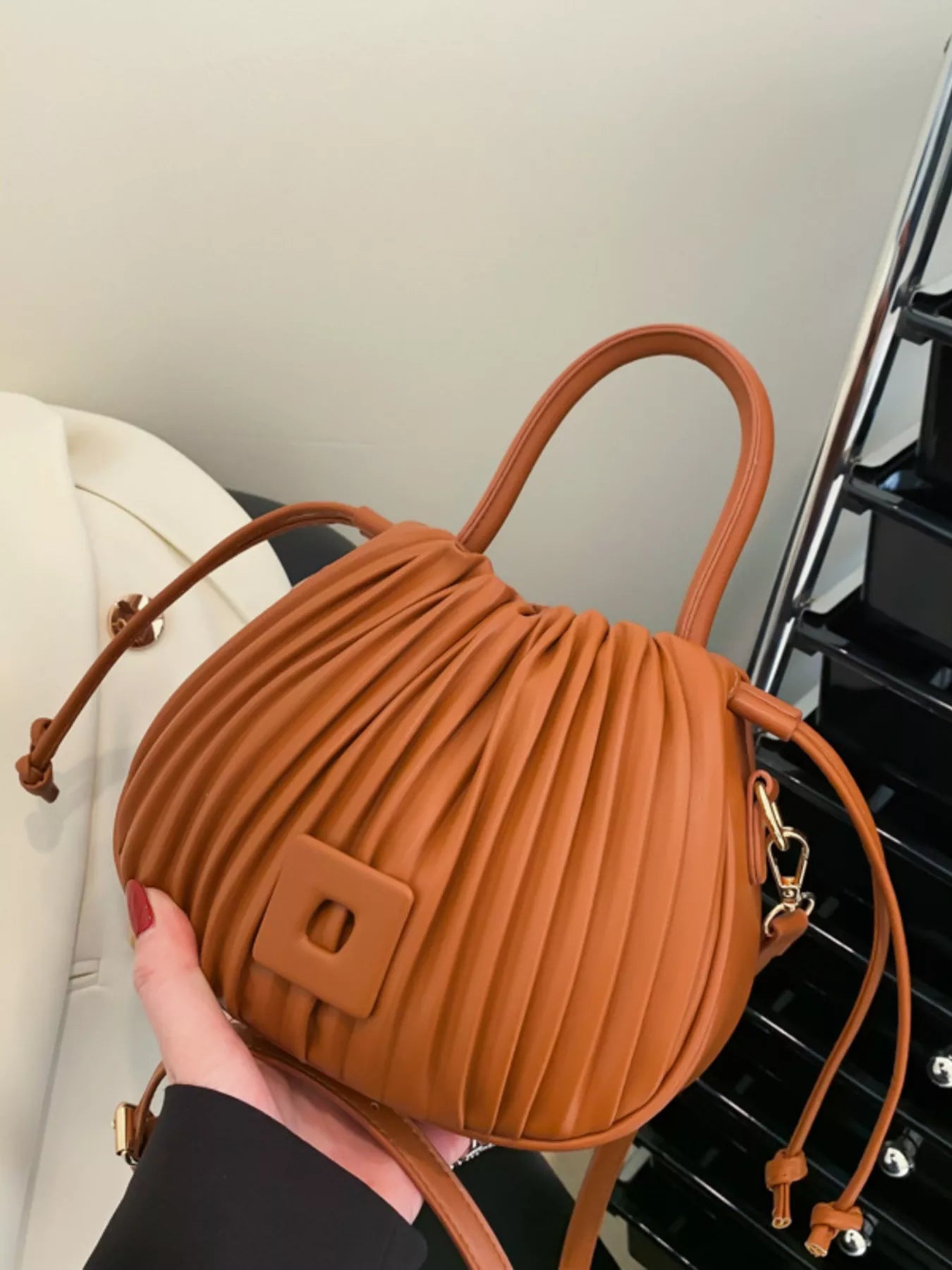 Trendsi pleated bucket crossbody bag with adjustable strap, showcasing a stylish handbag design in a neutral color.