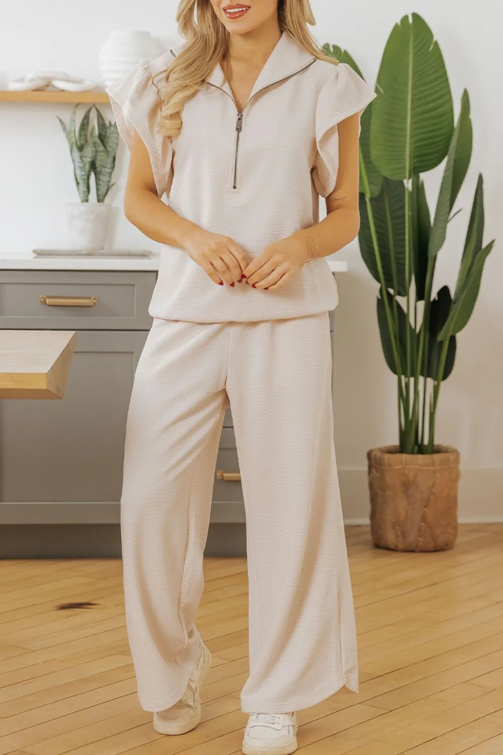 Textured ruffled sleeve zipped top and wide-leg pants set from Trendsi, featuring stylish design and comfortable fit.
