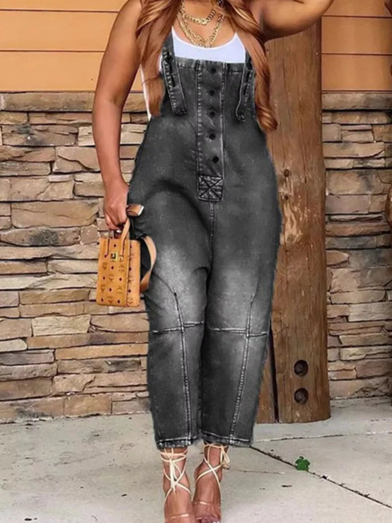 Denim button front overalls with pockets, featuring adjustable straps and classic denim texture, by Trendsi.