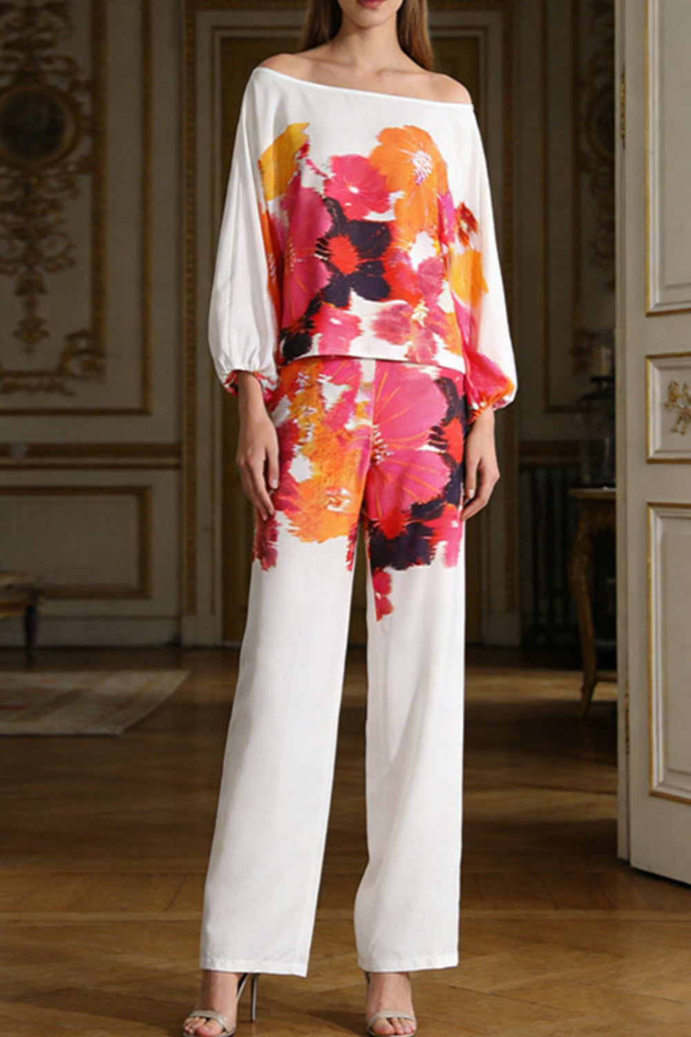 Floral print off-shoulder top and matching pants set by Trendsi, featuring vibrant flowers and relaxed fit for casual wear.