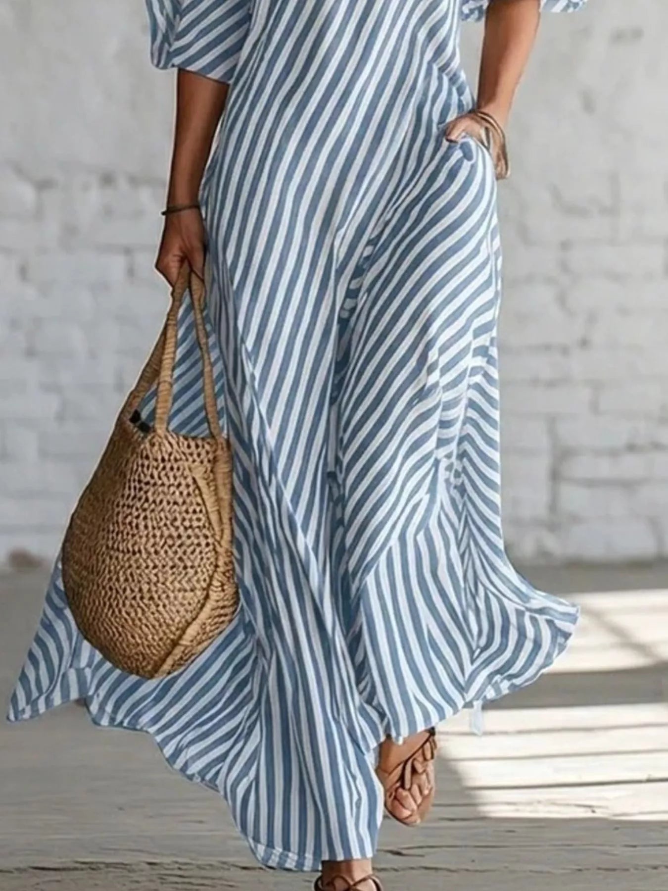 Striped one-shoulder maxi dress by Trendsi featuring a flowing silhouette and bold color pattern, perfect for summer occasions.