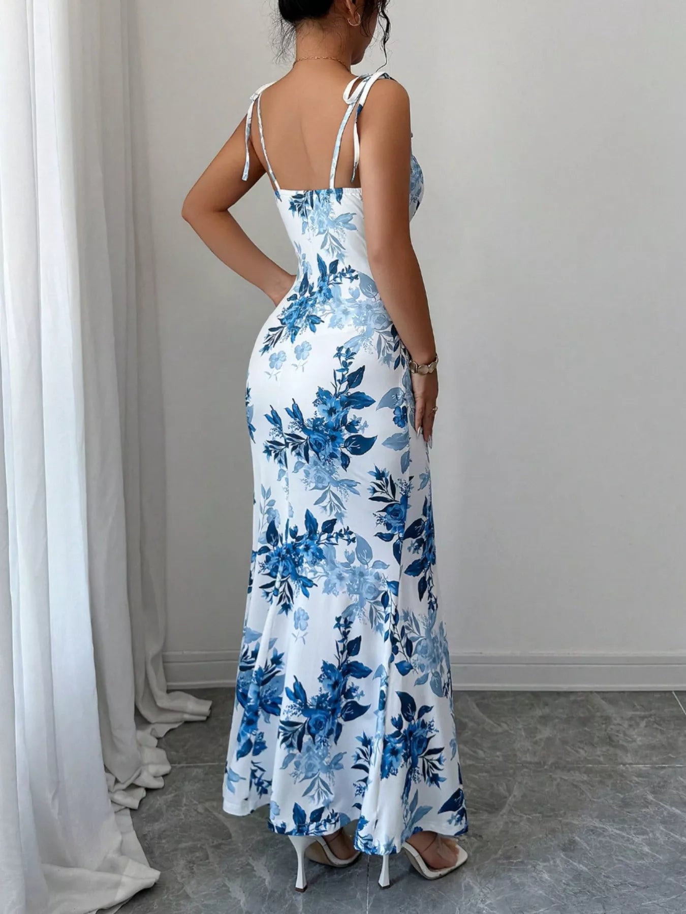 Printed tie strap slit maxi dress by Trendsi featuring a flowy silhouette, adjustable straps, and a stylish slit detail.
