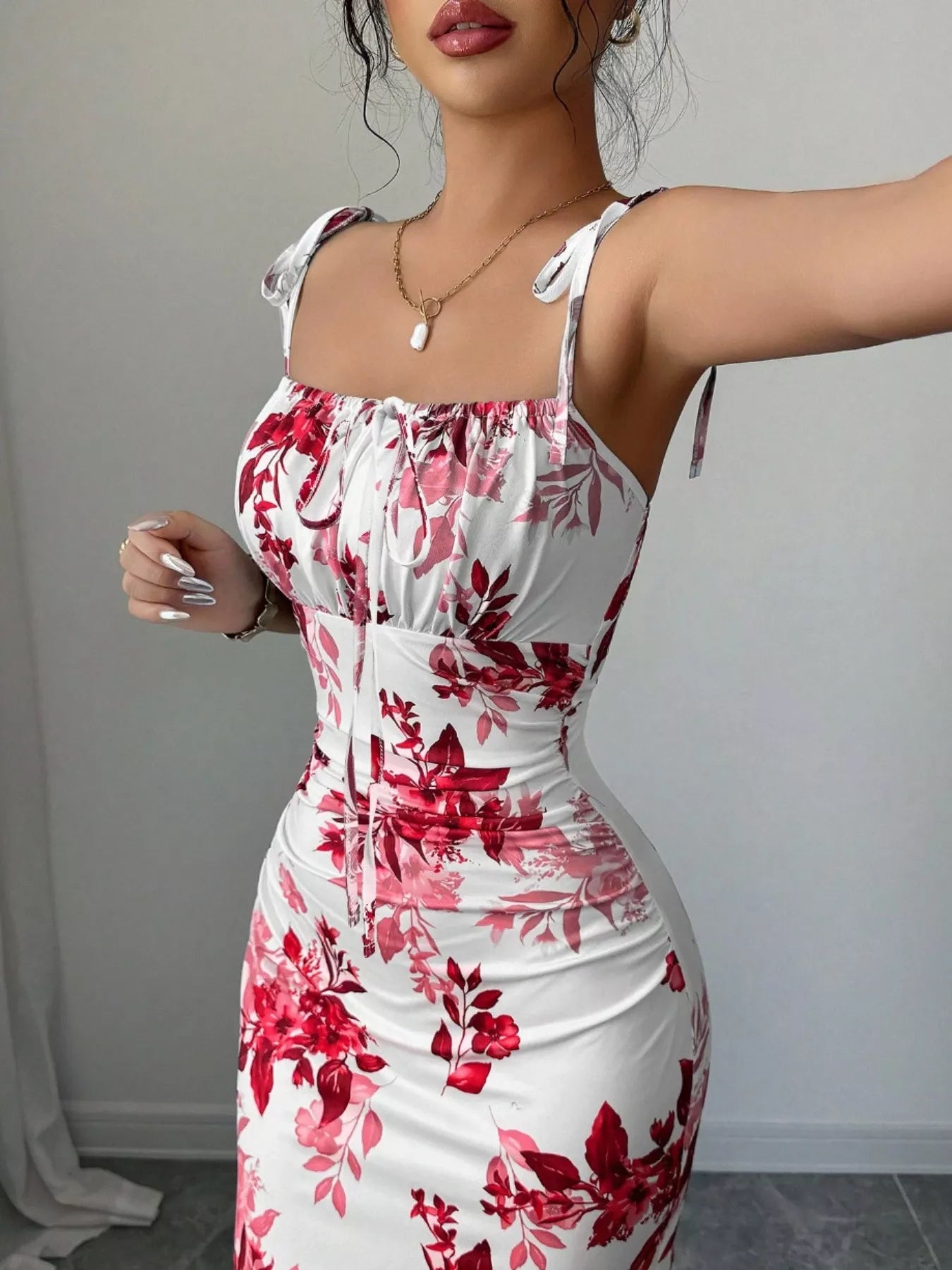 Printed tie strap slit maxi dress from Trendsi featuring a flowing silhouette, adjustable straps, and a stylish slit design.