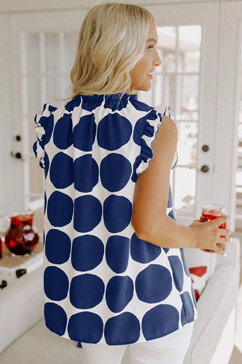 Polka dot ruffled sleeve cami top from Trendsi, featuring lightweight fabric and feminine ruffle details, perfect for casual wear.