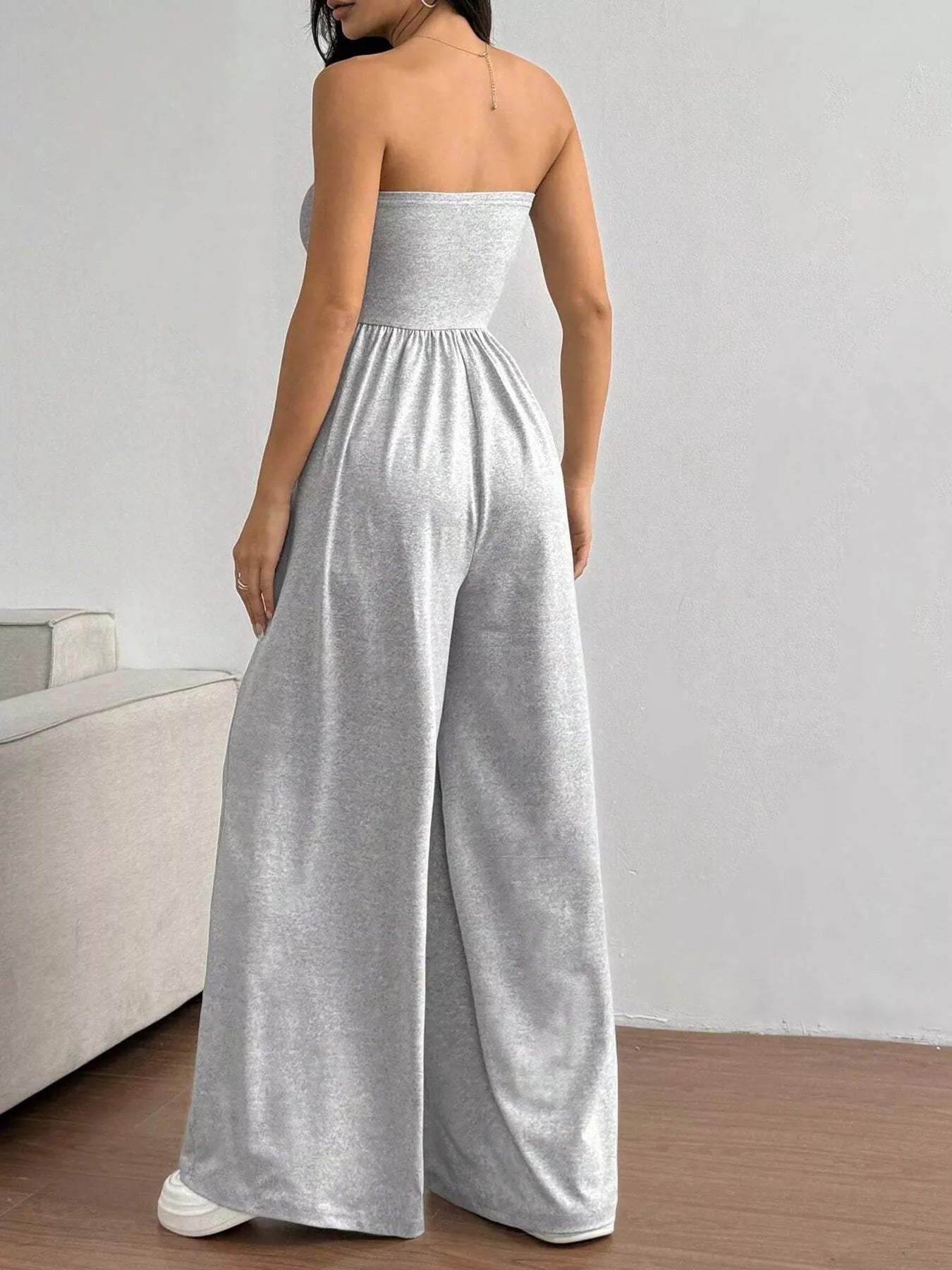 Trendsi chic tube top wide-leg jumpsuit with sleeveless design and relaxed fit, displayed on a hanger.