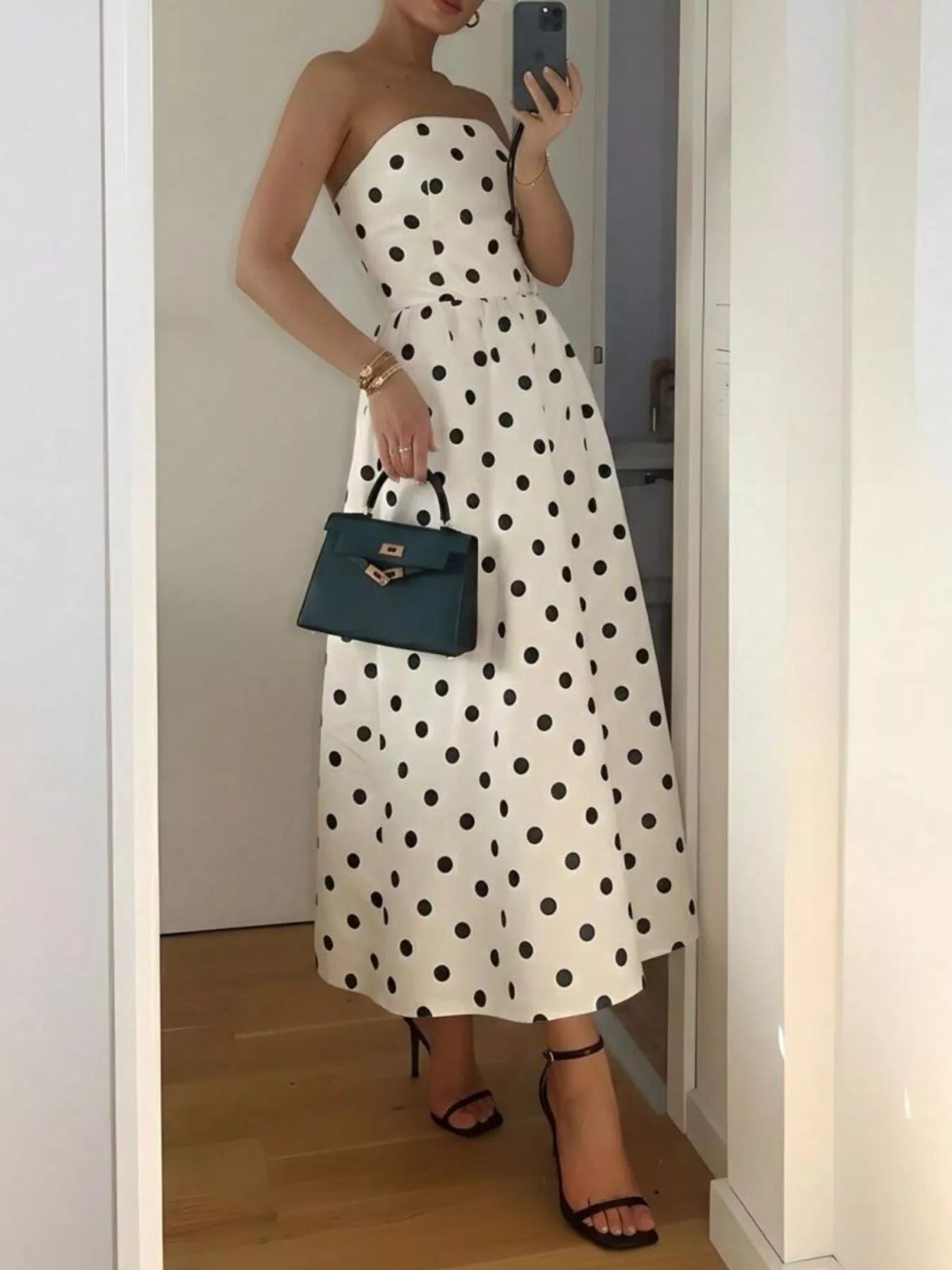 Polka dot strapless midi dress from Trendsi featuring a fitted bodice and flowing skirt, perfect for summer or special occasions.