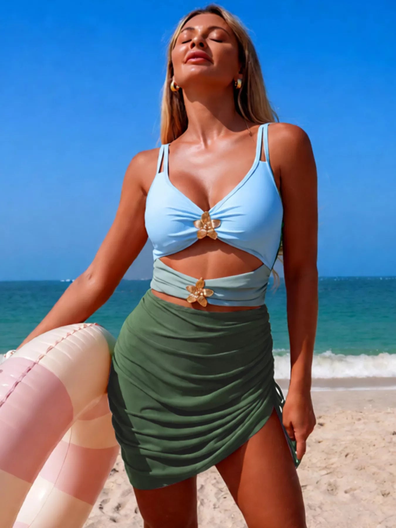 Color block cutout one-piece swimsuit by Trendsi featuring bold color blocks and stylish cutout details.