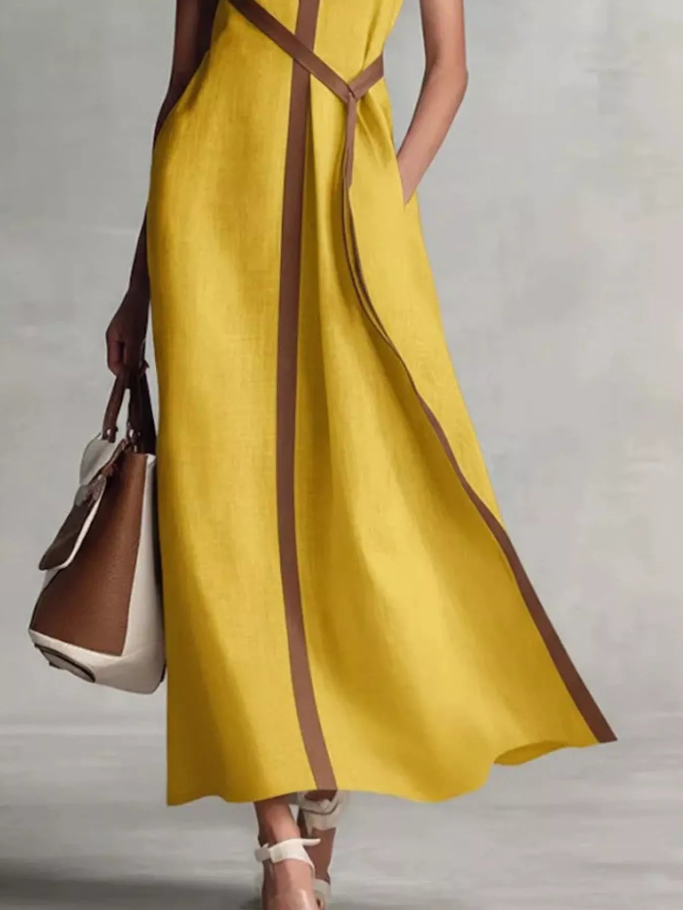 Sleeveless maxi dress with contrast trim, flowing design, and stylish details, from Trendsi. Perfect for elegant summer occasions.